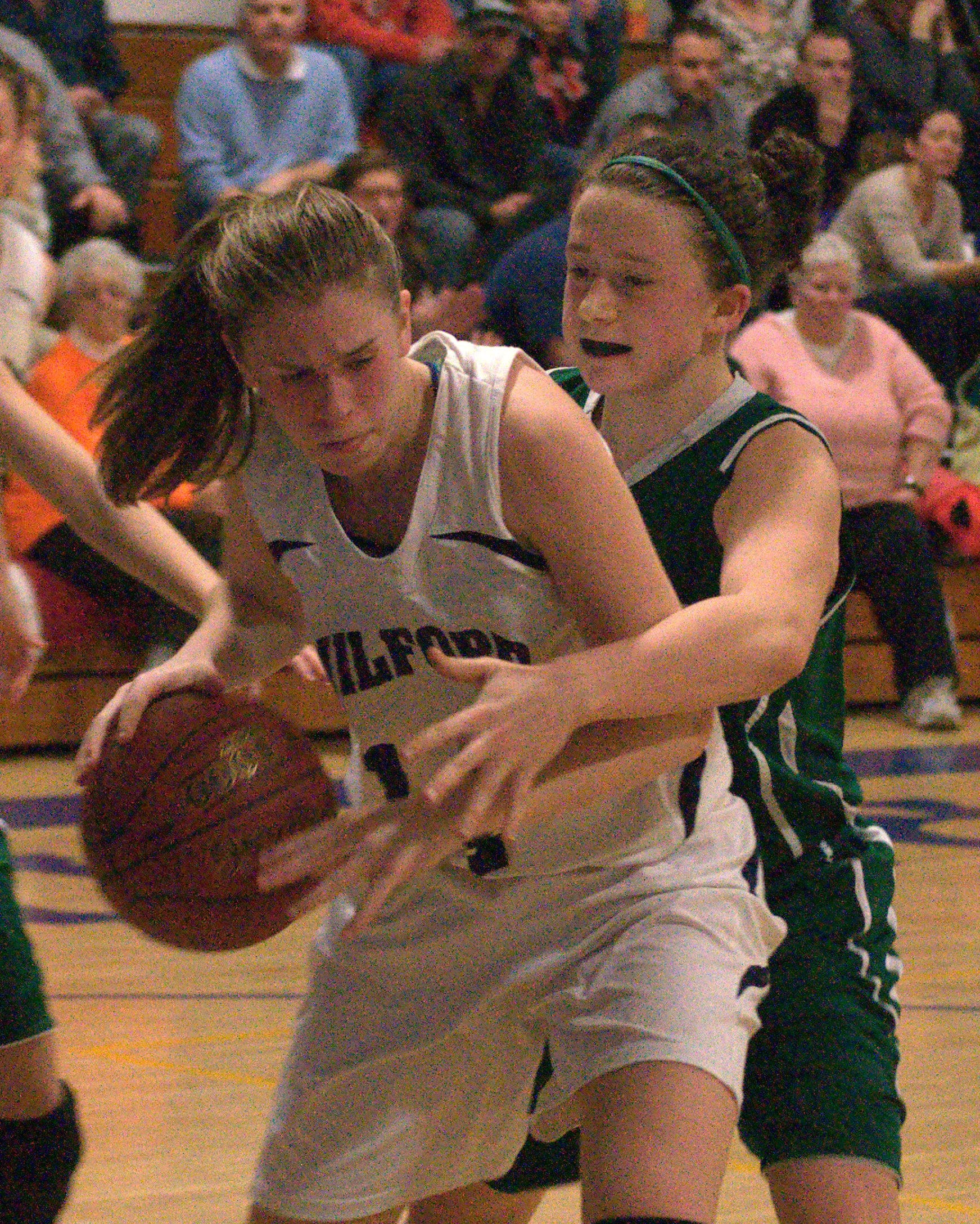 Milford's Jessica Ryan tries to keep a rebound away from Pembroke's Molly Hamilton. For more photos, go to the Photo Album.