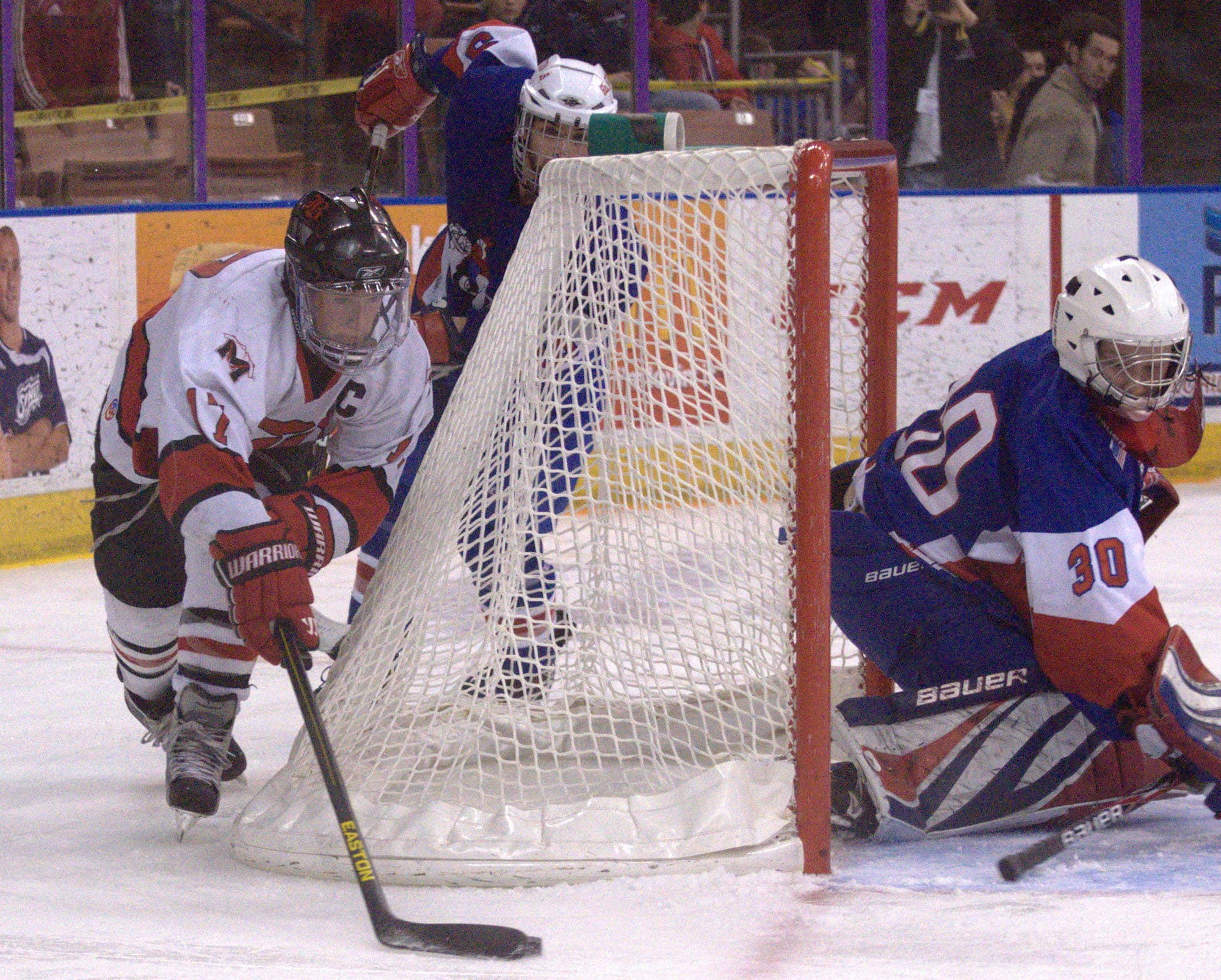 Berlin's Connor Jewett tries to go around the goal to score on John Stark/Hopkinton's Connor McDonald.