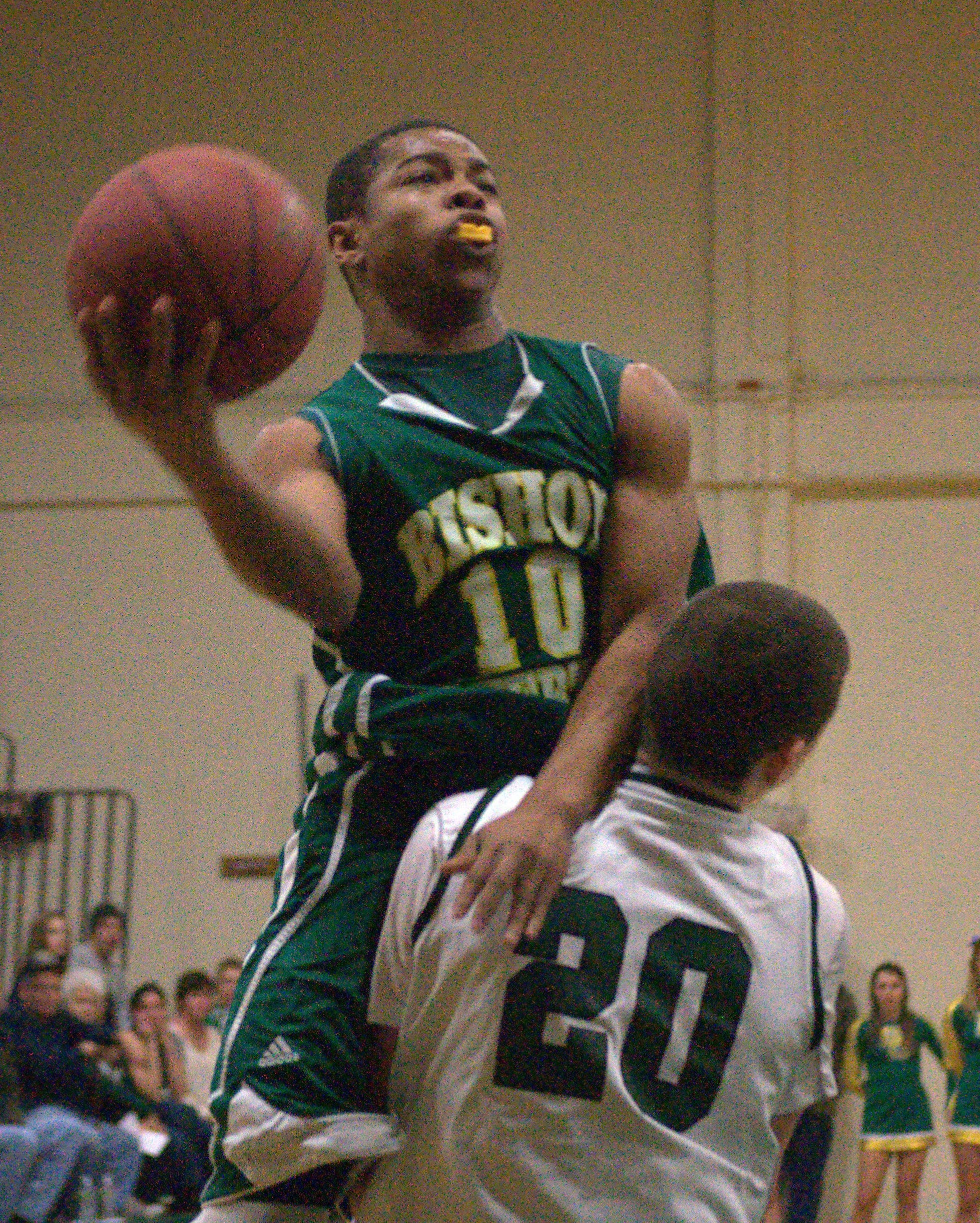 Bishop Guertin's CJ Boykin drives to the basket as Manchester Central's Nick Makris defends during Friday's game.