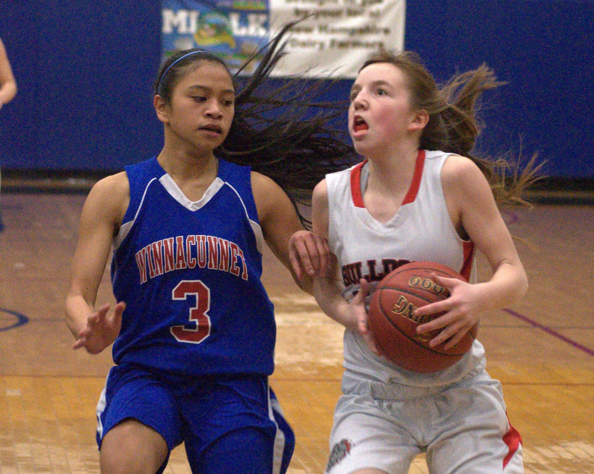 Bedford's Brianna Purcell drives to the basket as Winnacunnet's Maelan Castro defends.