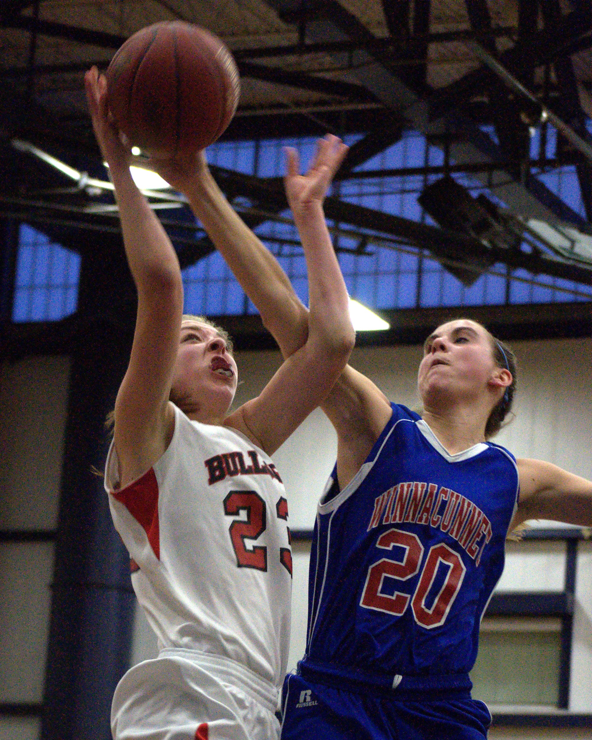Winnacunnet's Melissa MacLeod blocks a shot by Bedford's Ali Glennon during Thursday's game. For more photos, go to the Photo Album.