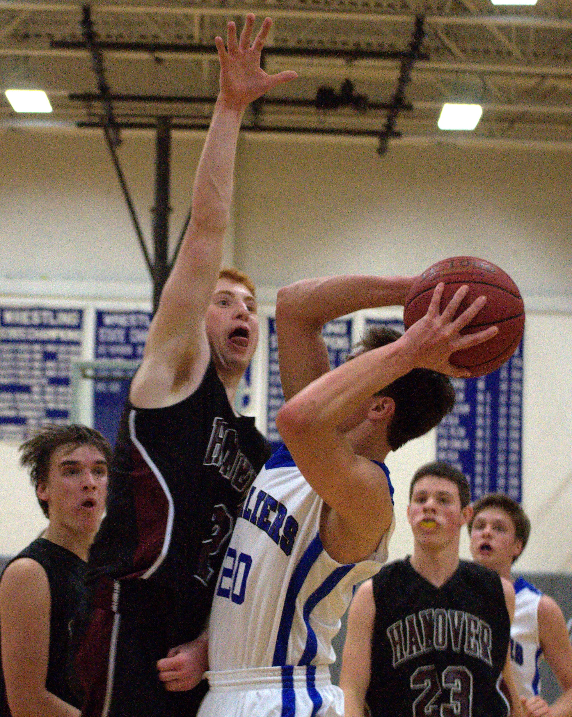Hanover's John Flory tries to block a shot by Hollis Brookline's Ryan Papineau.