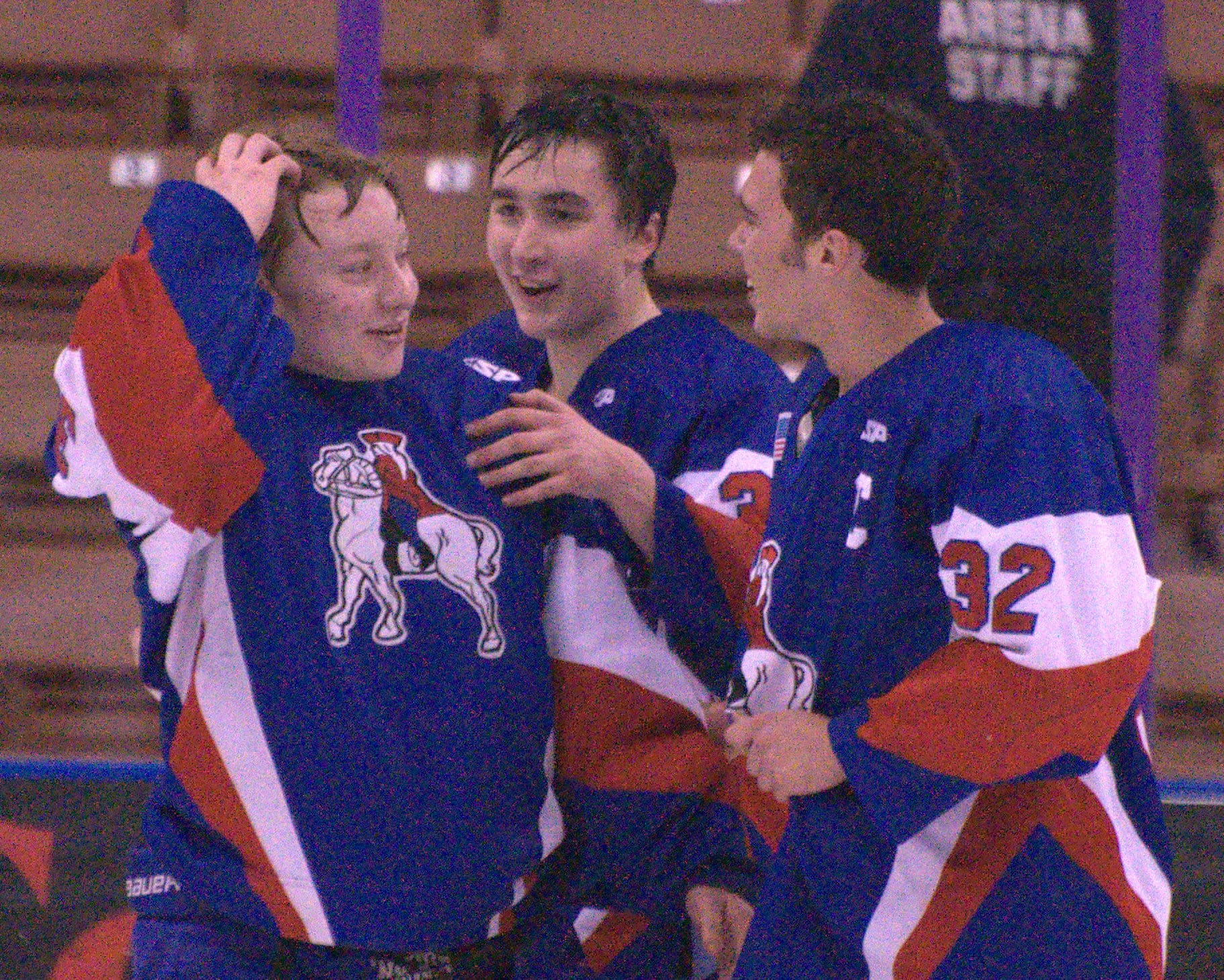 From left, Connor McDonald, Keith Galli and Simon Hunter celebrate after John Stark/Hopkinton defeated Berlin to win the Division III boys hockey title.