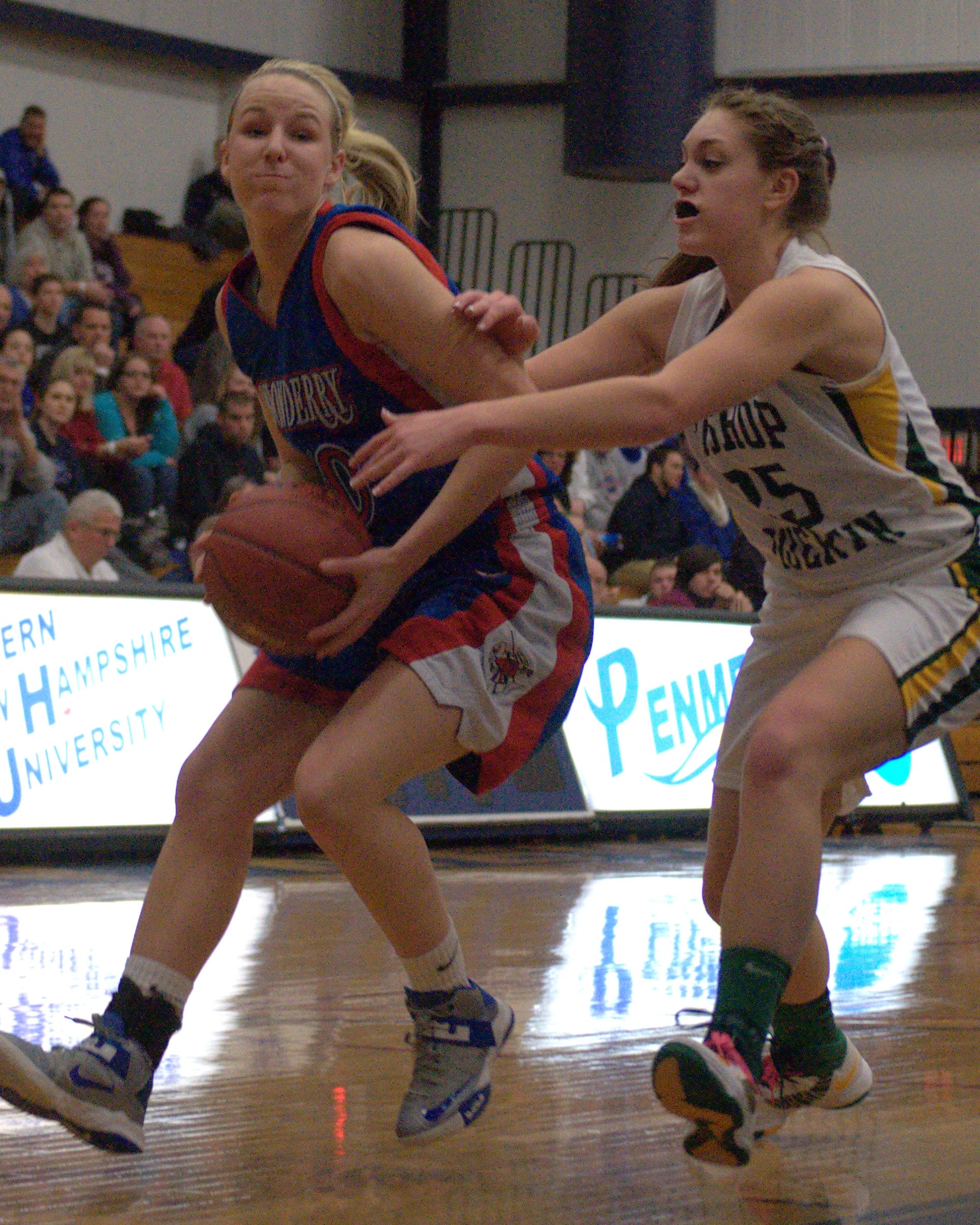 Bishop Guertin's Madison Gibbs tries to slow down Londonderry's Aliza Simpson as she drives to the basket Thursday. For more photos, go to the Photo Album.