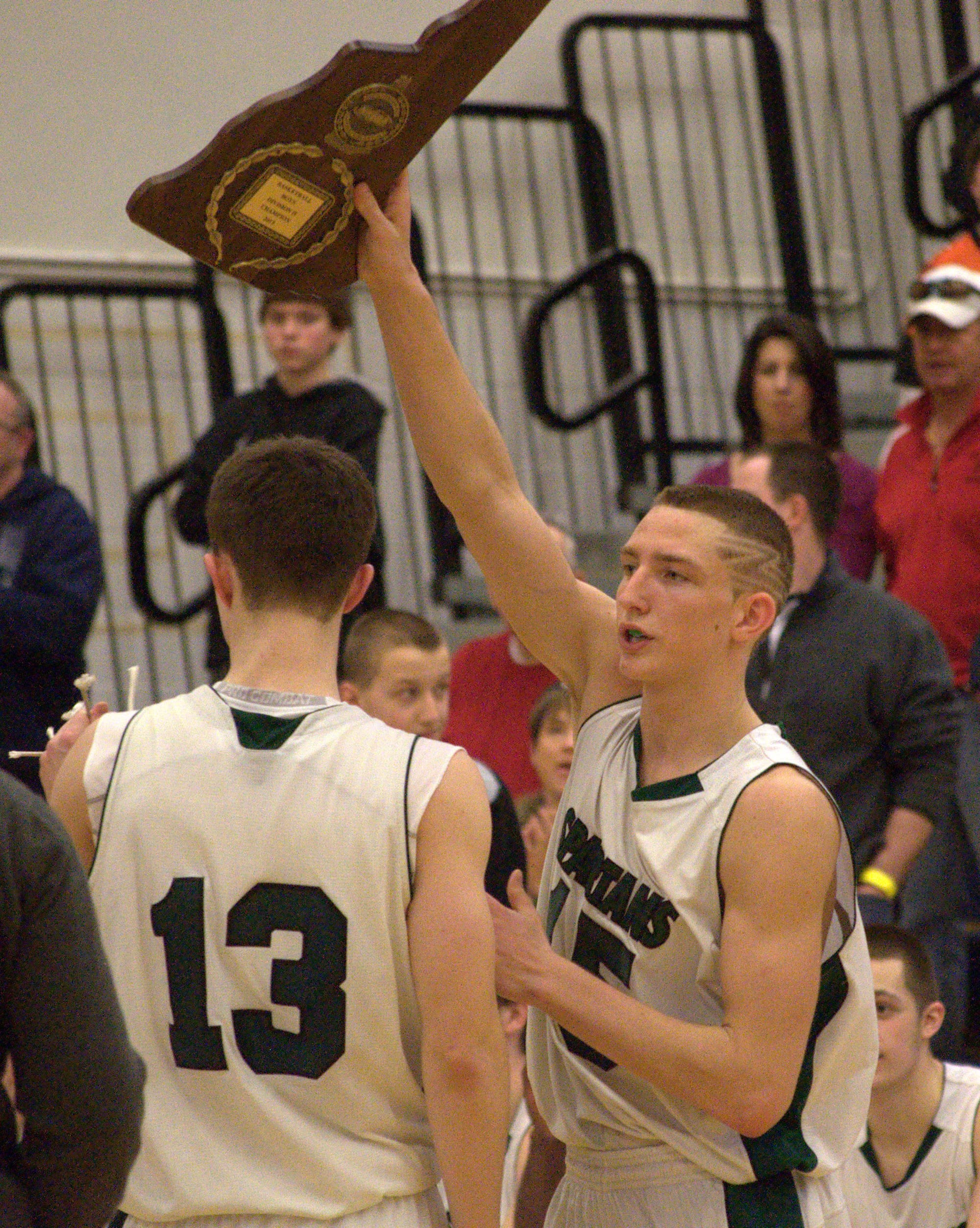 Pembroke's Patrick Welch holds up the Division II championship plaque after the Spartans beat Souhegan on Saturday. For more photos, go to the Photo Album.