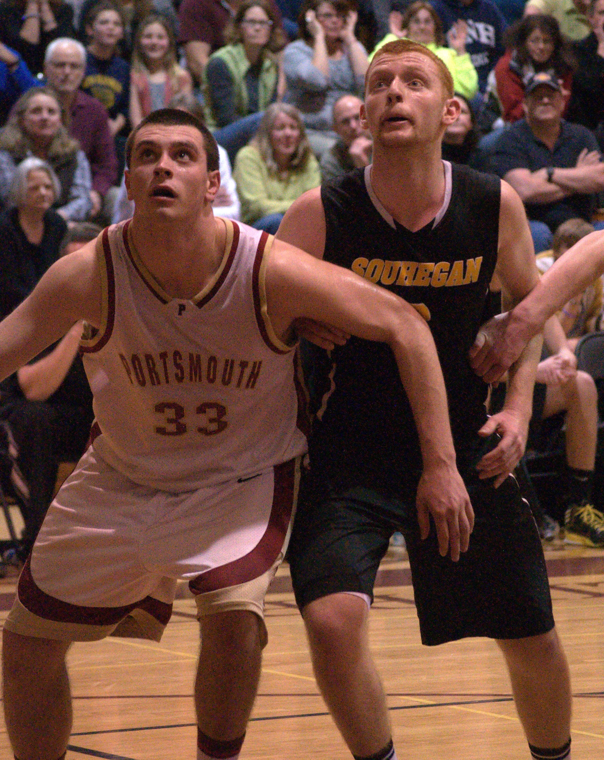 Souhegan's Zach Simmonds and Portsmouth's Patrick Glynn wait for a rebound.