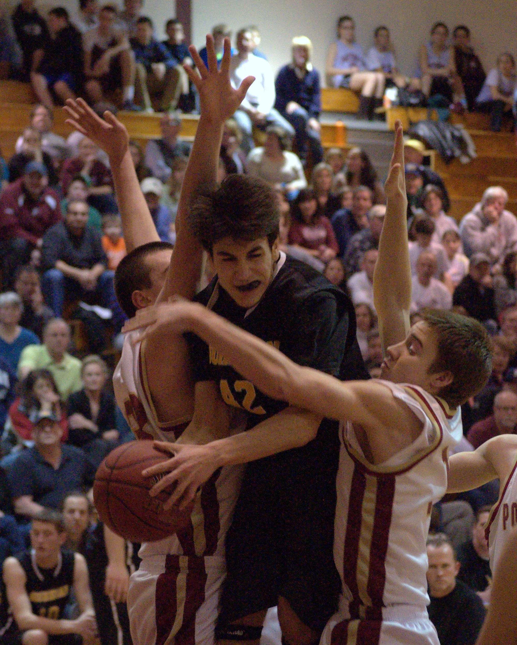 Souhegan's Brandon Len is fouled on his way to the basket during Saturday's playoff game against Portsmouth.