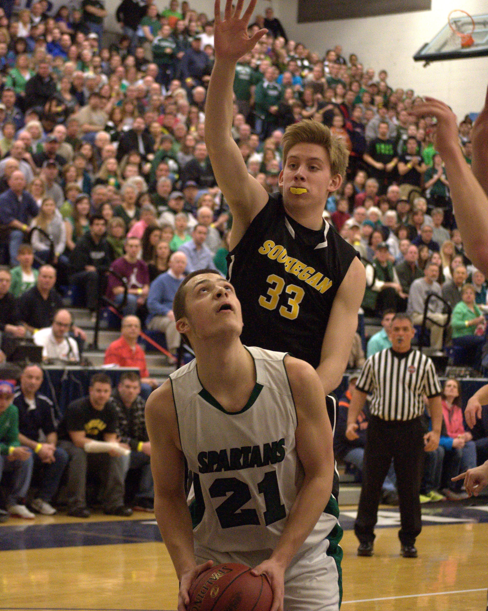 Souhegan's Matt Protzman defends Pembroke's Dominic Timbas.