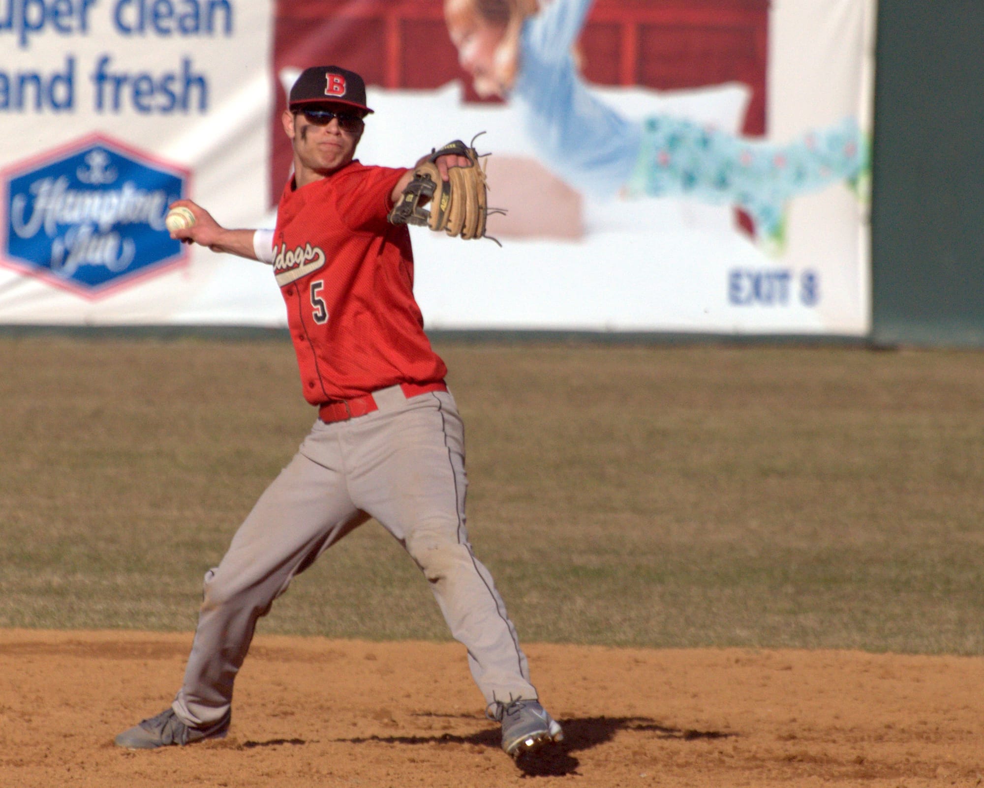 Bedford's Ben Philbrick makes a throw to first base.