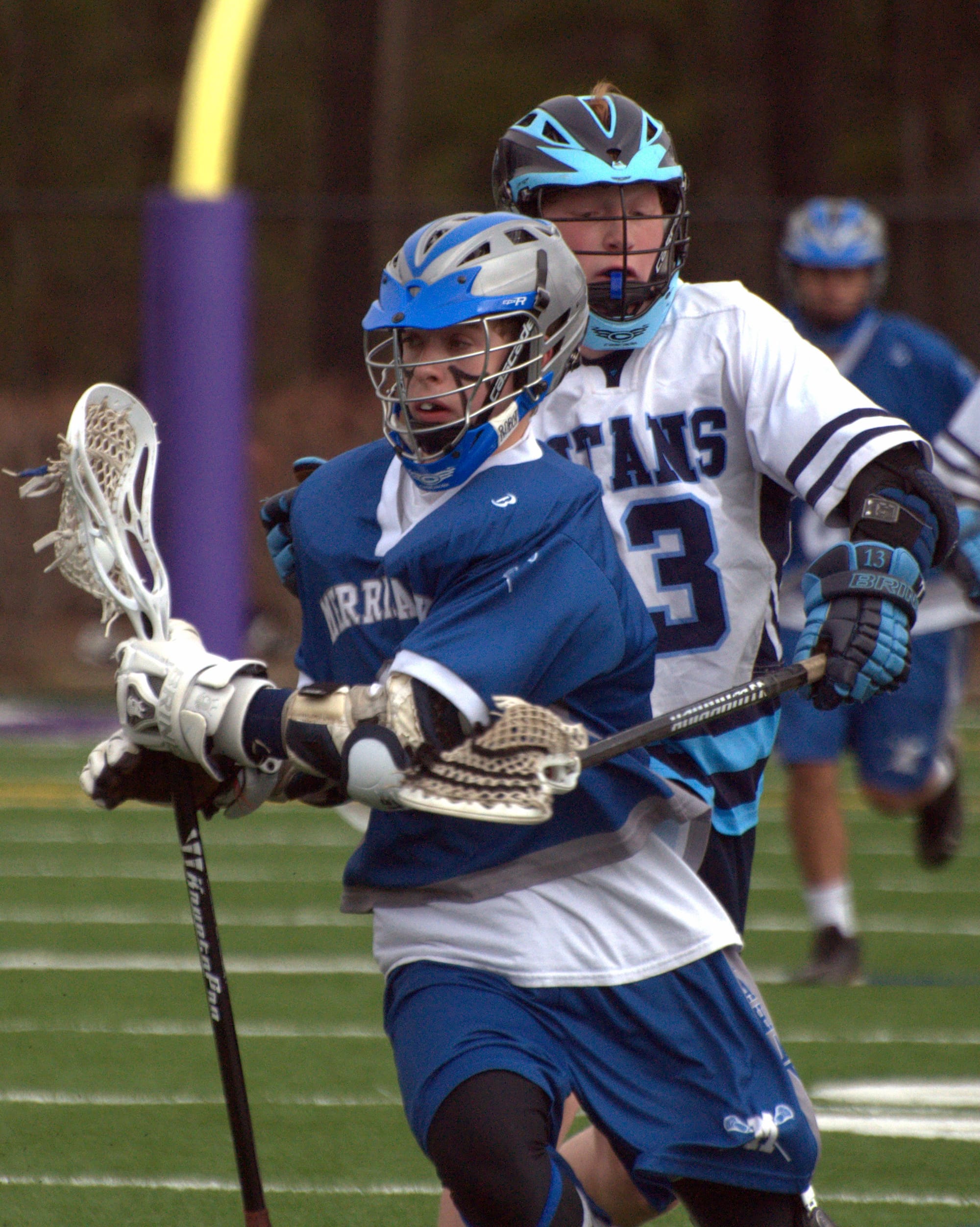 Nashua North's Jon Searles tries to knock the ball away from Merrimack's Connor Cyr.