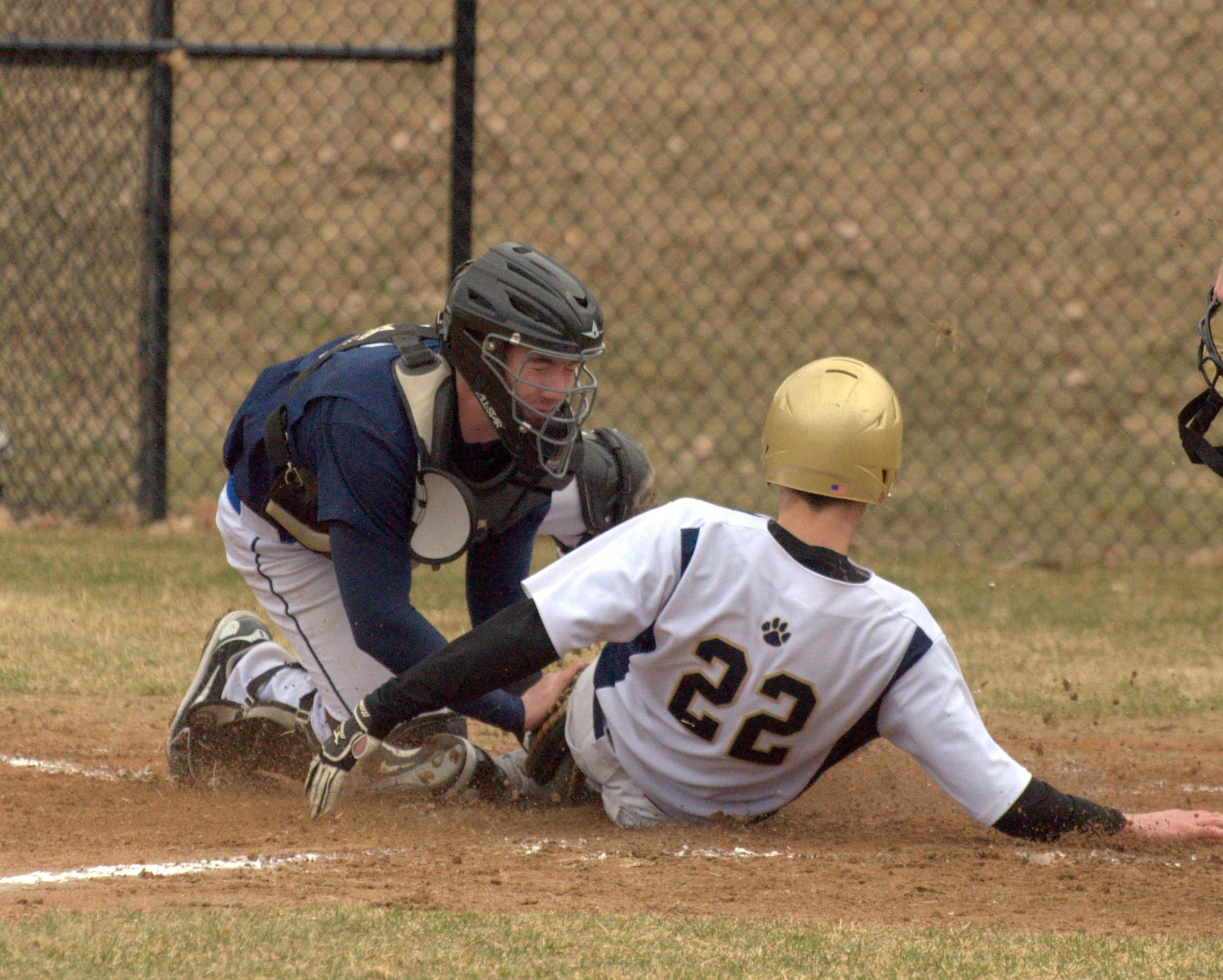 Milford's Cam Dougals tags Windham's David Carbonello.