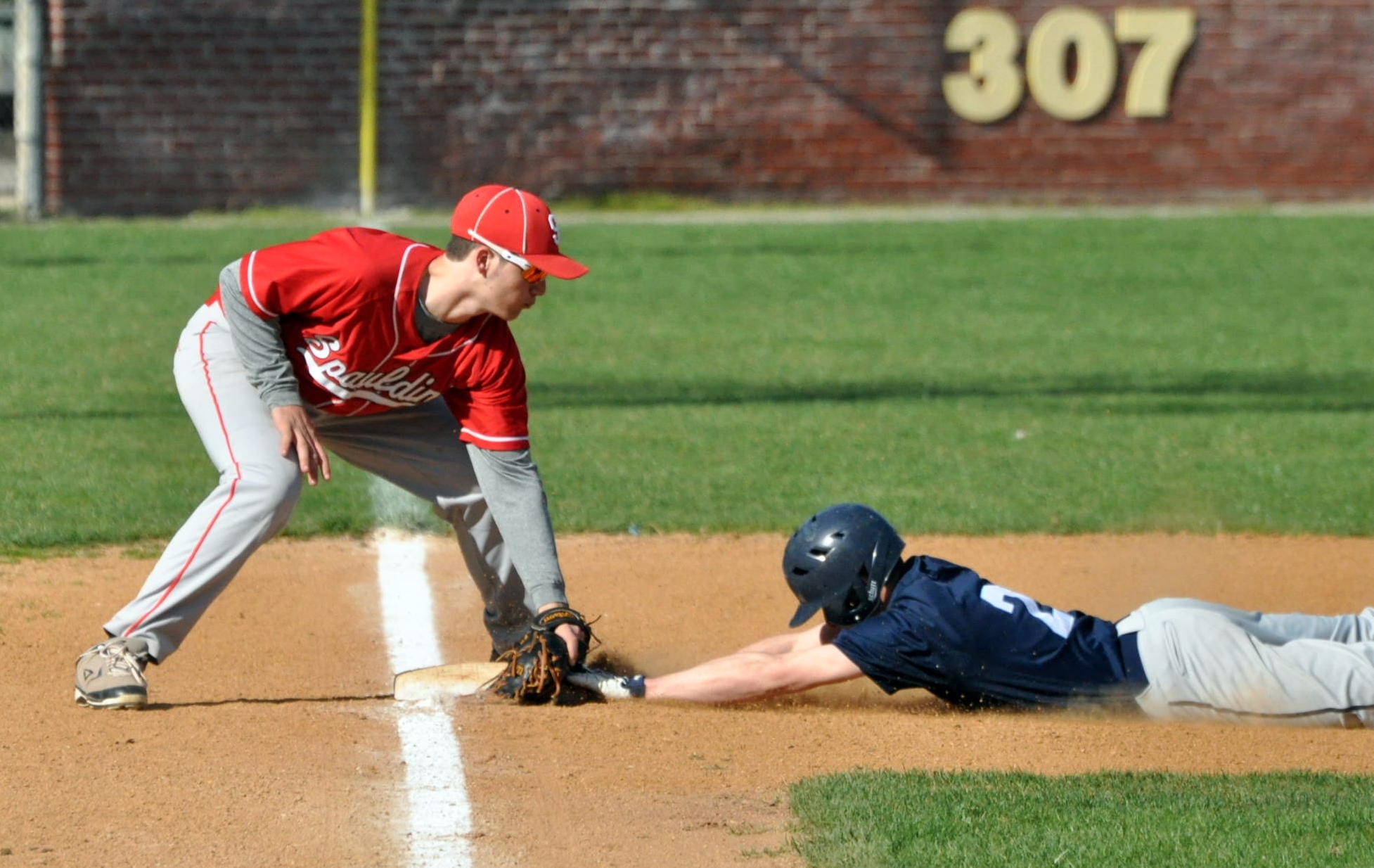 Spaulding's Loukas Brigham tags Nashua North's Spencer Madden at third during Wednesday's game. For more photos, go to the Photo Album.