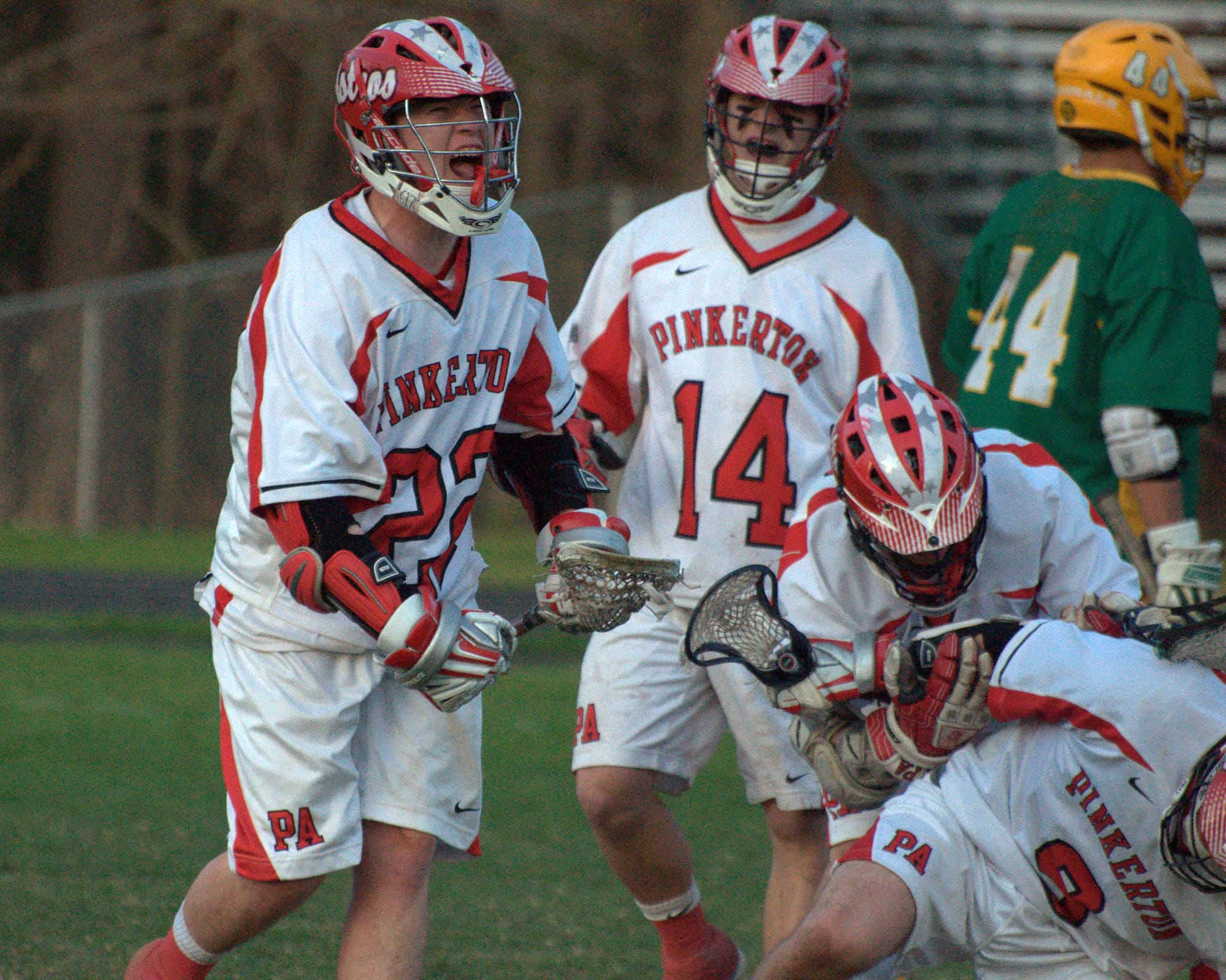 Pinkerton's Josh Gallant (No. 22) celebrates with his teammates after scoring a goal Monday.