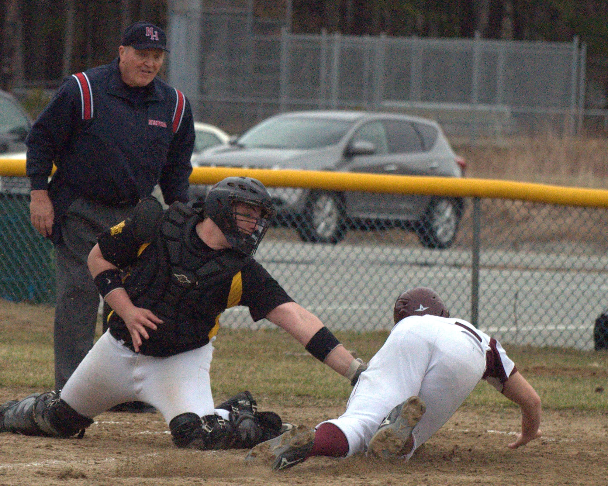 Lebanon's Grayson Hardy is tagged out at home by Souhegan's Cam Crook. For more photos, go to the Photo Album.