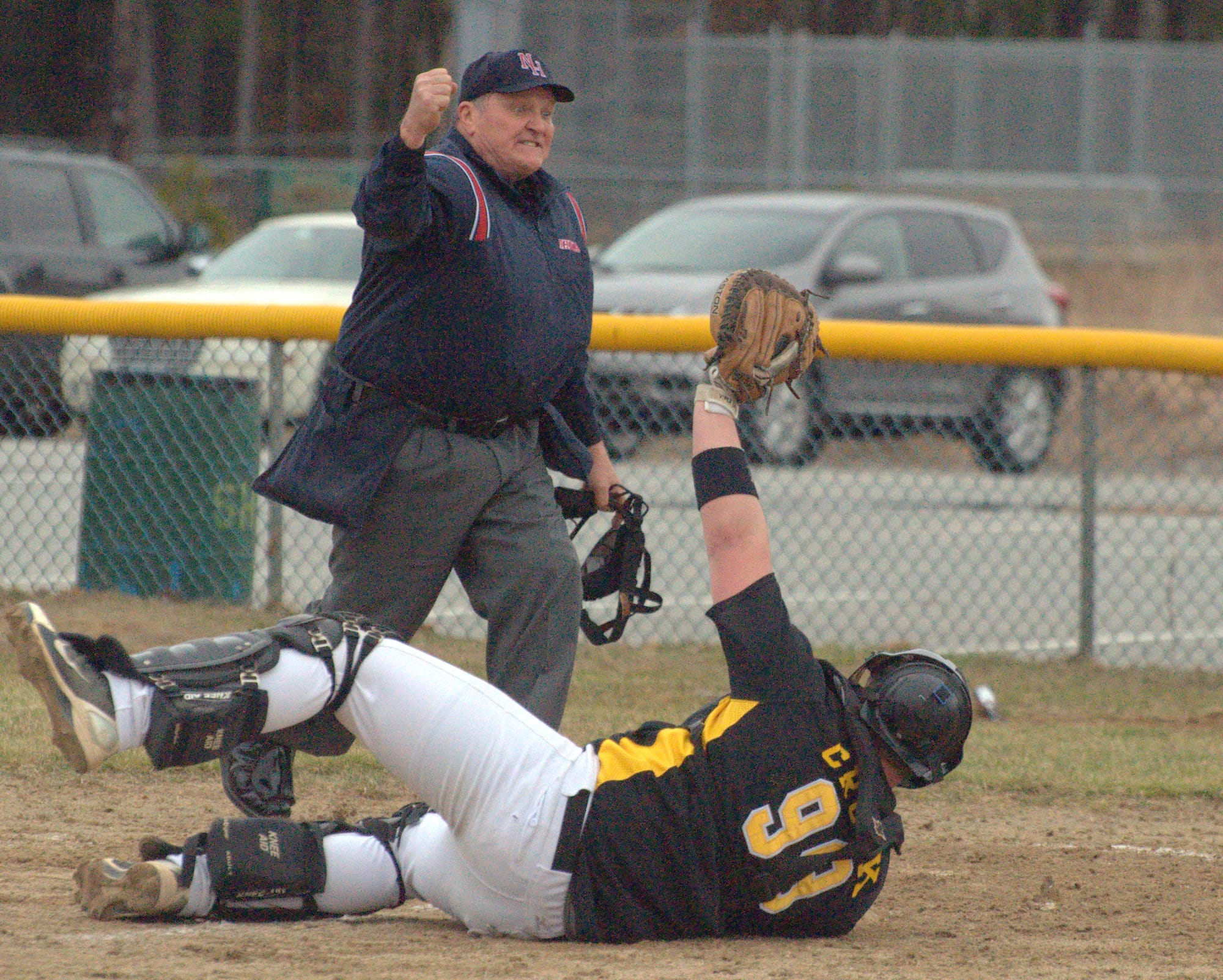 Souhegan catcher Cam Crook holds up the ball after tagging Lebanon's Grayson Hardy during last Wednesday's game.