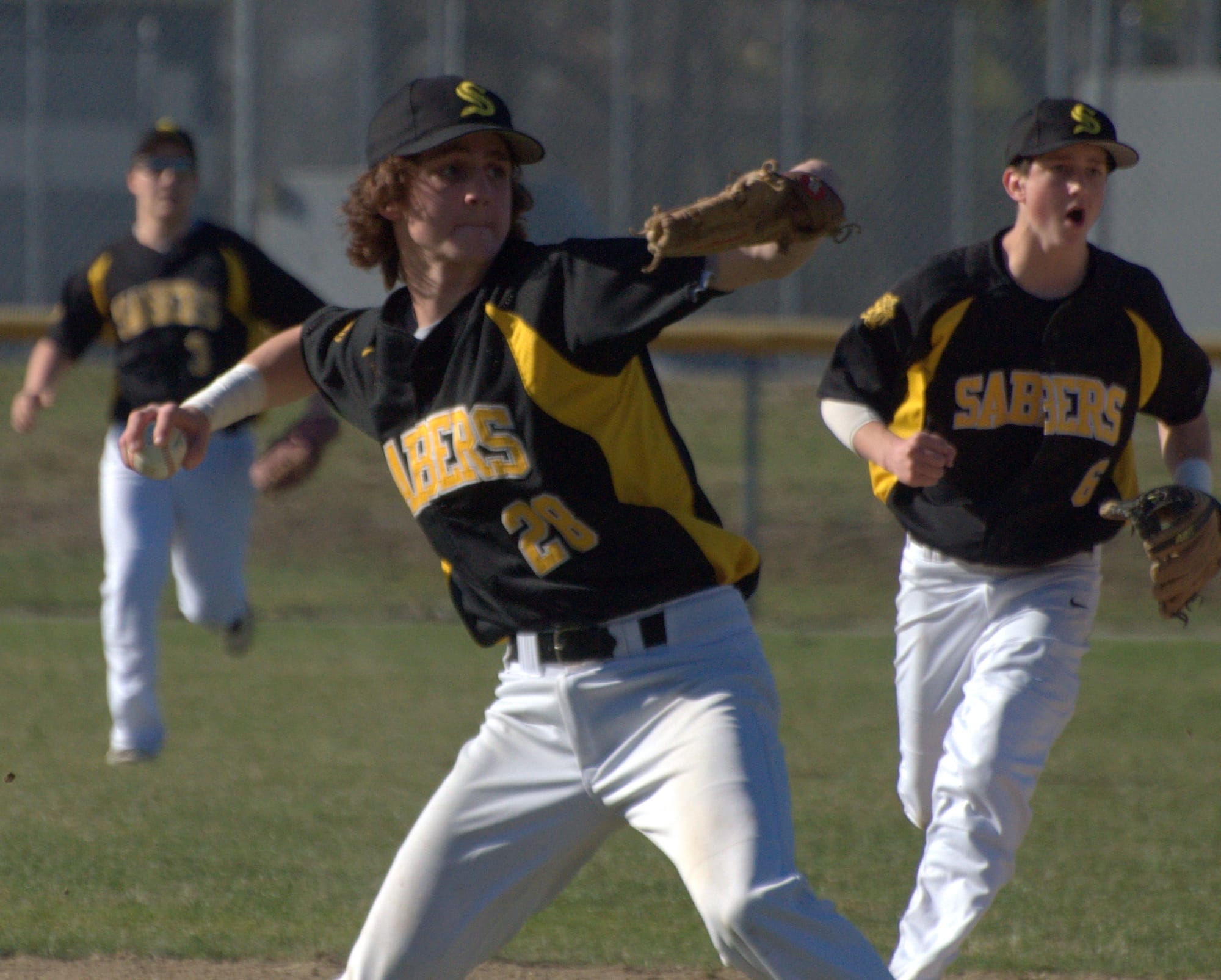 Souhegan's Peter Bennett makes the throw to first base.