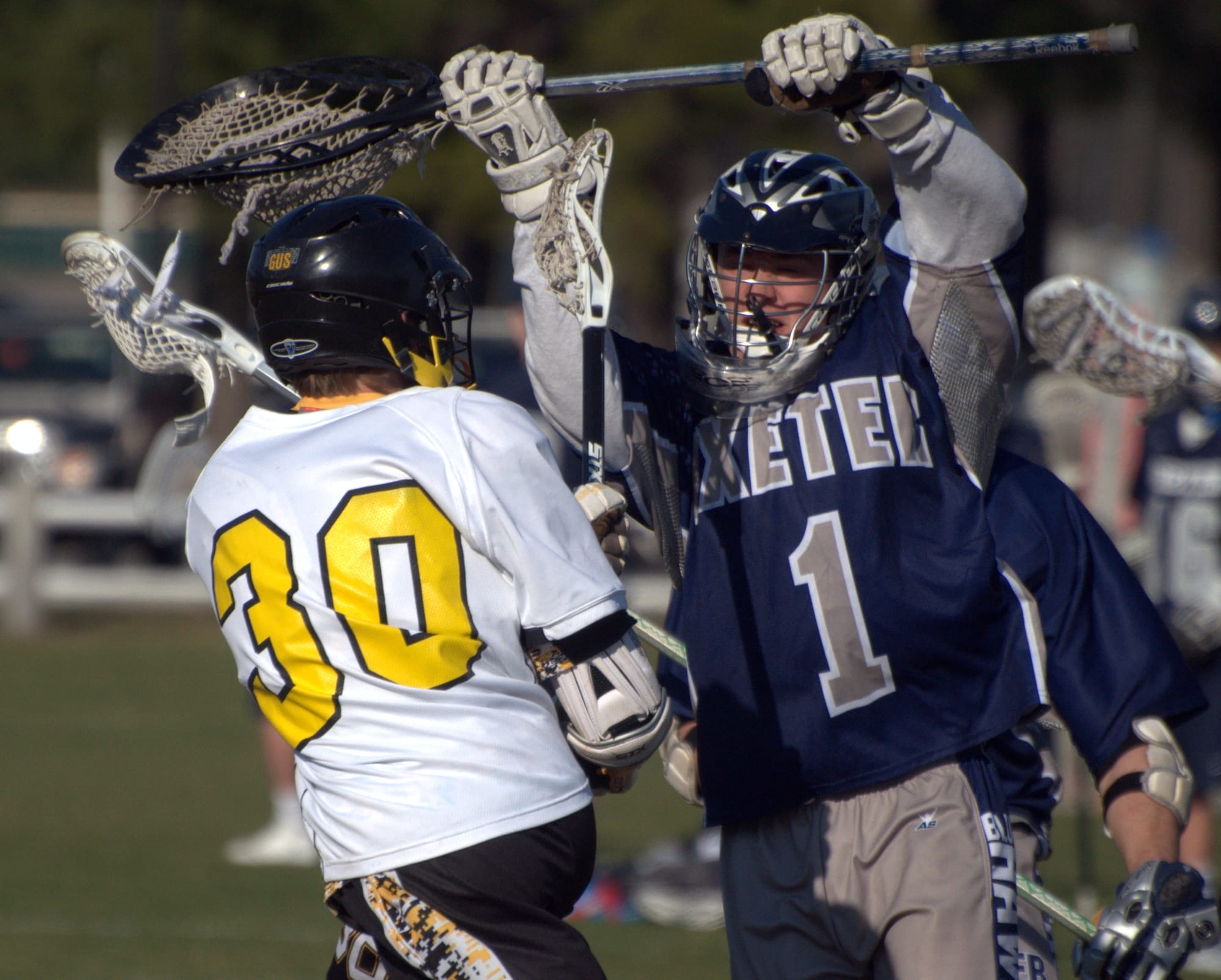 Exeter goalie Cole Finerty jumps in front of Souhegan's Blake Burnley during Monday's game.
