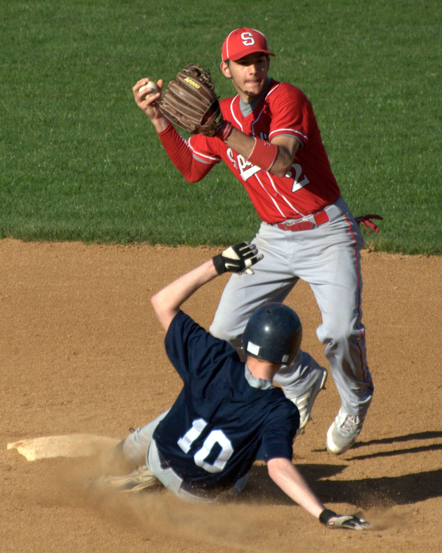 Spaulding's Mike Bellio tries to turn a double play.