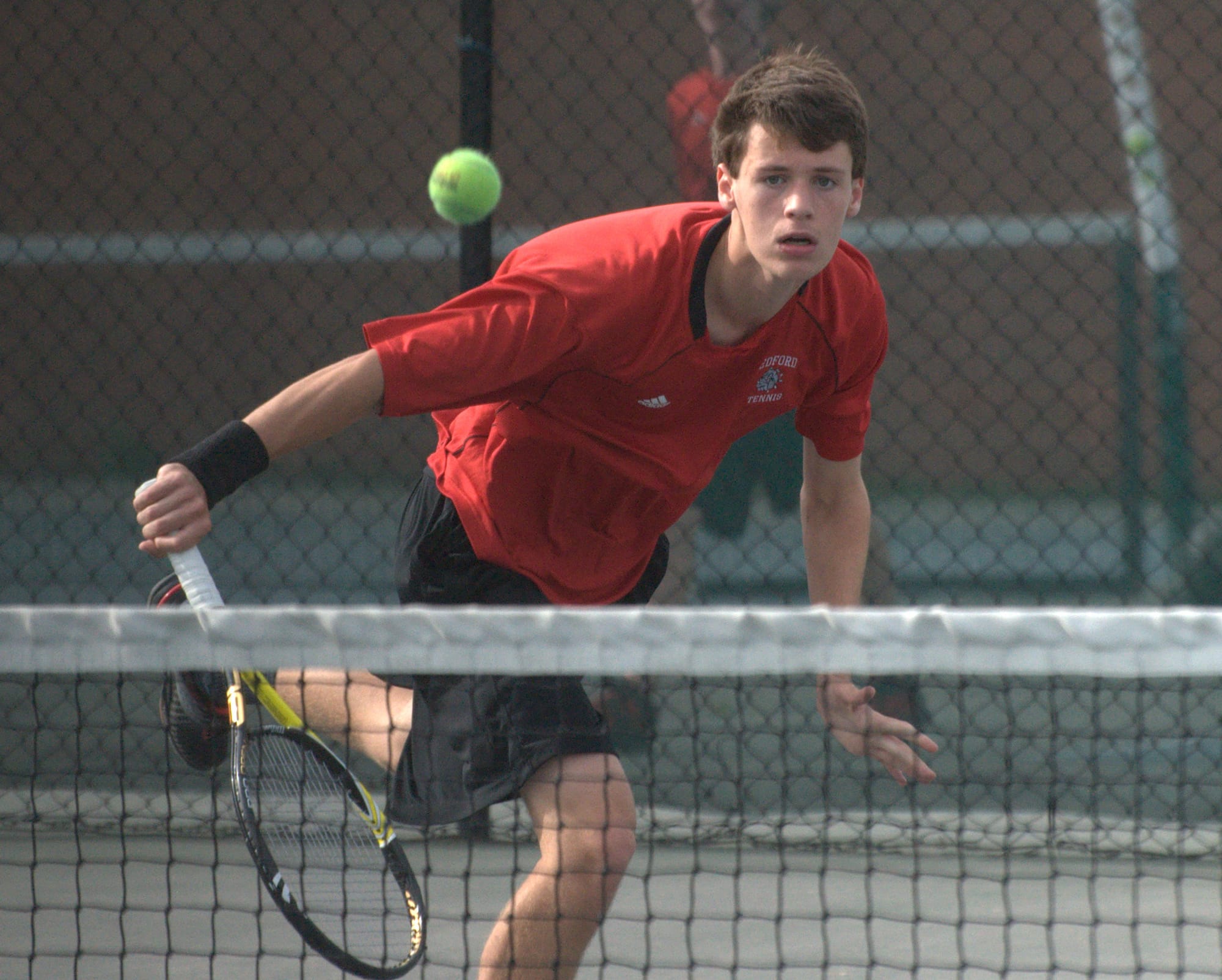 Bedford's McKinley Grimes watches as his shot goes over the net during Tuesday's championship match against Exeter.
