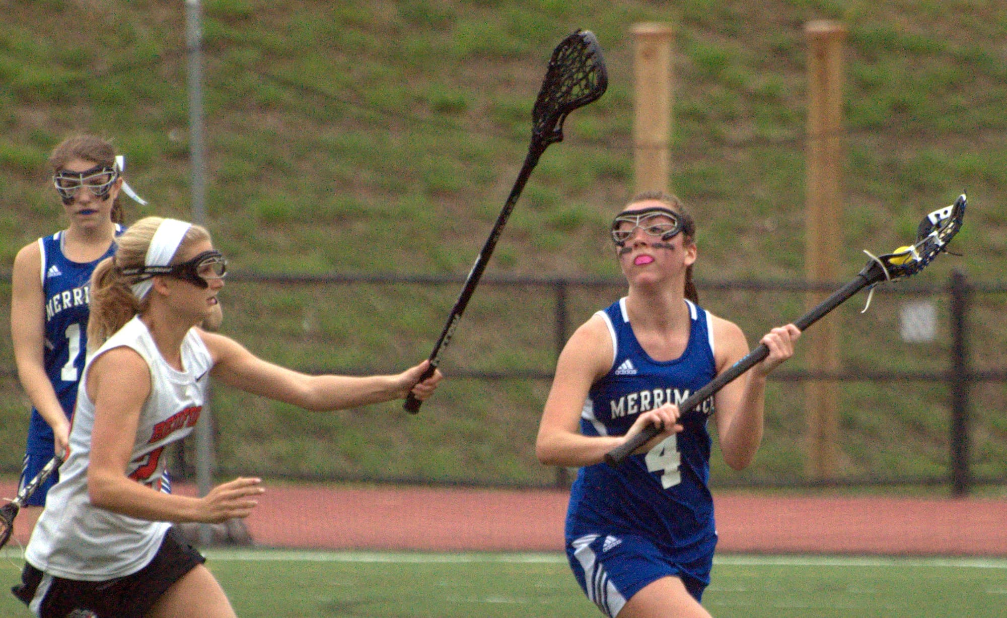 Bedford's Drew Shapiro tries to slow down Merrimack's Amber Olson during Wednesday's playoff game.