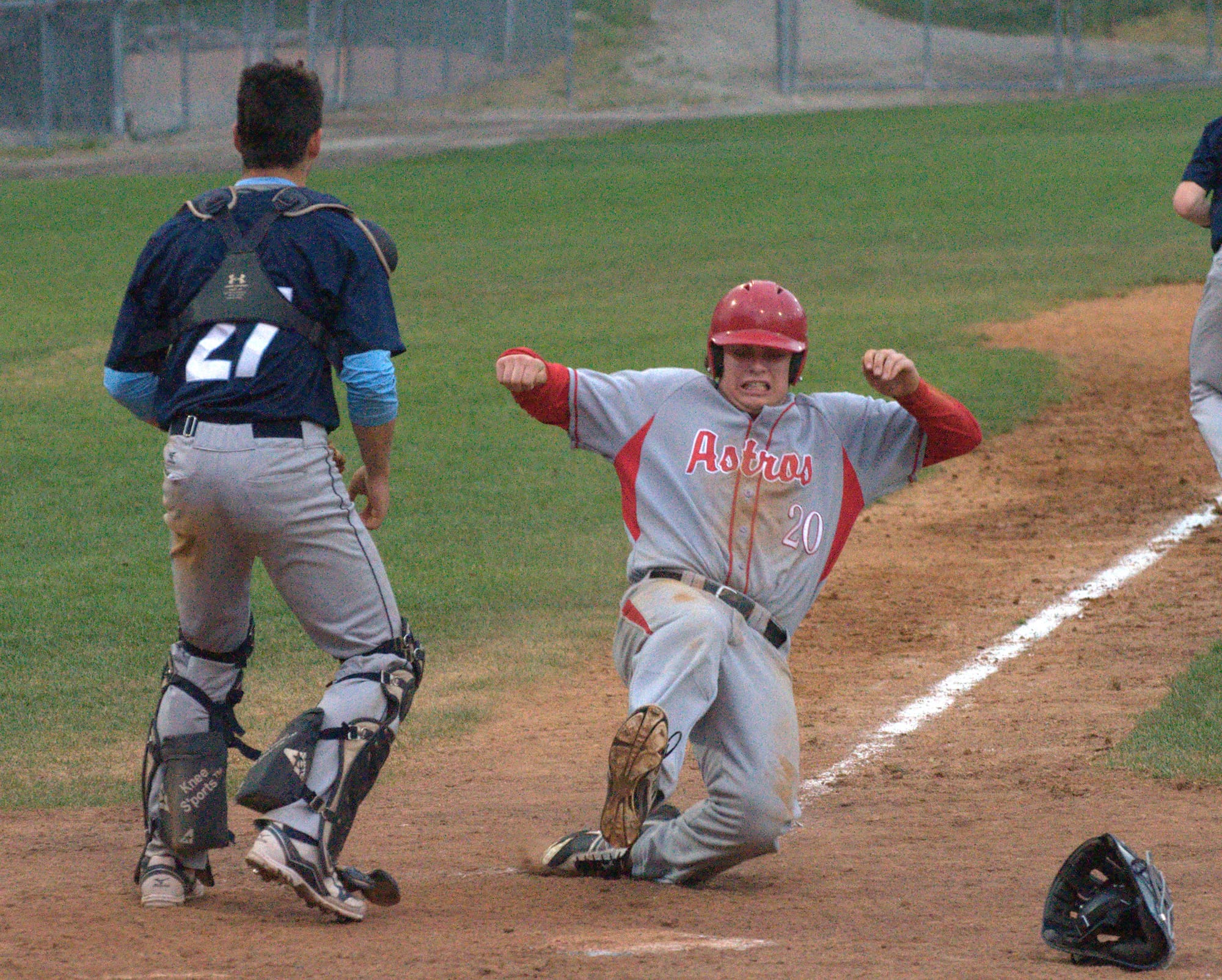 Pinkerton's Connor Donohue slides safely into home.