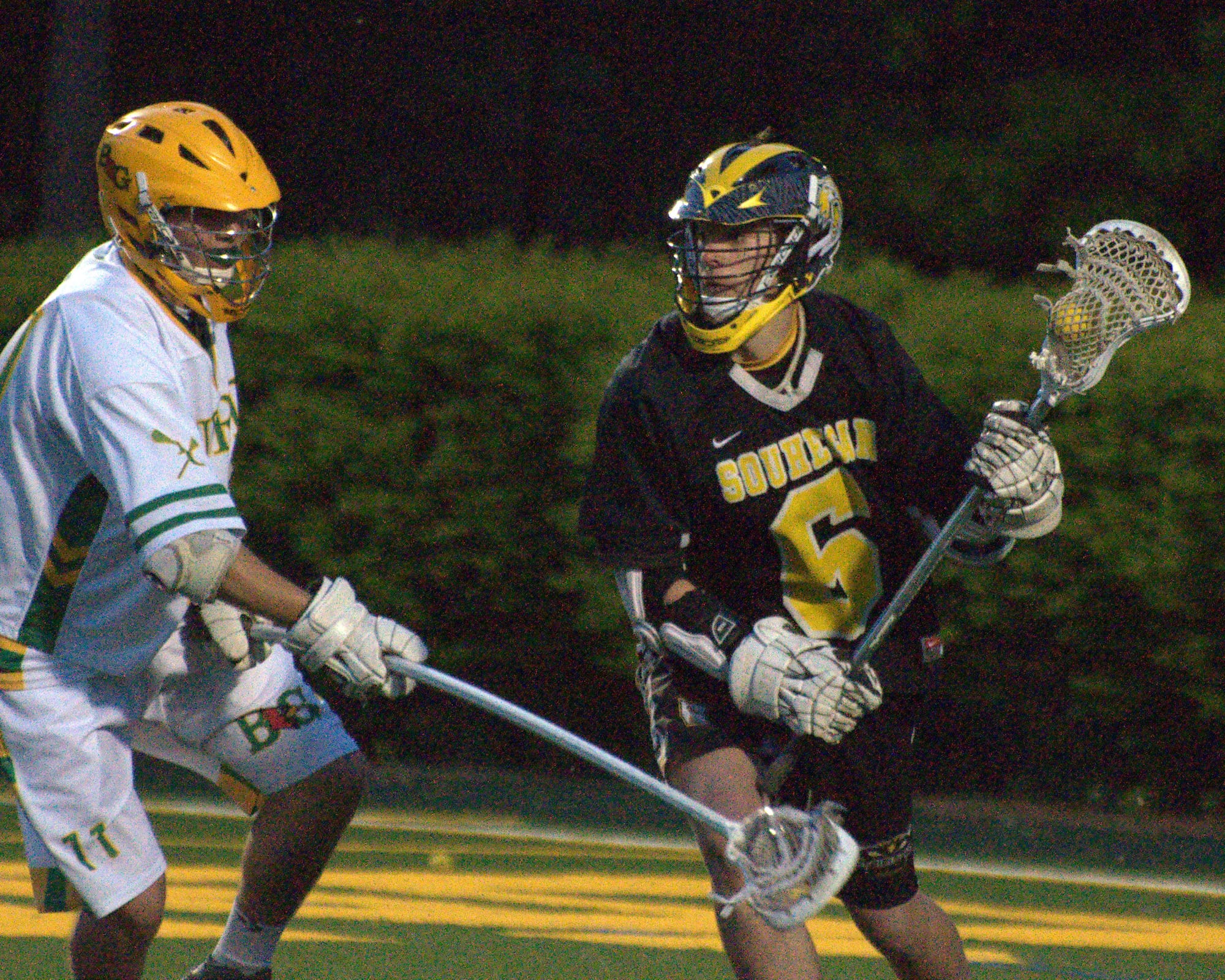 Bishop Guertin's Cody McInnis tries to slow down Souhegan's Mitch Hale during Tuesday's game at Stellos Stadium.