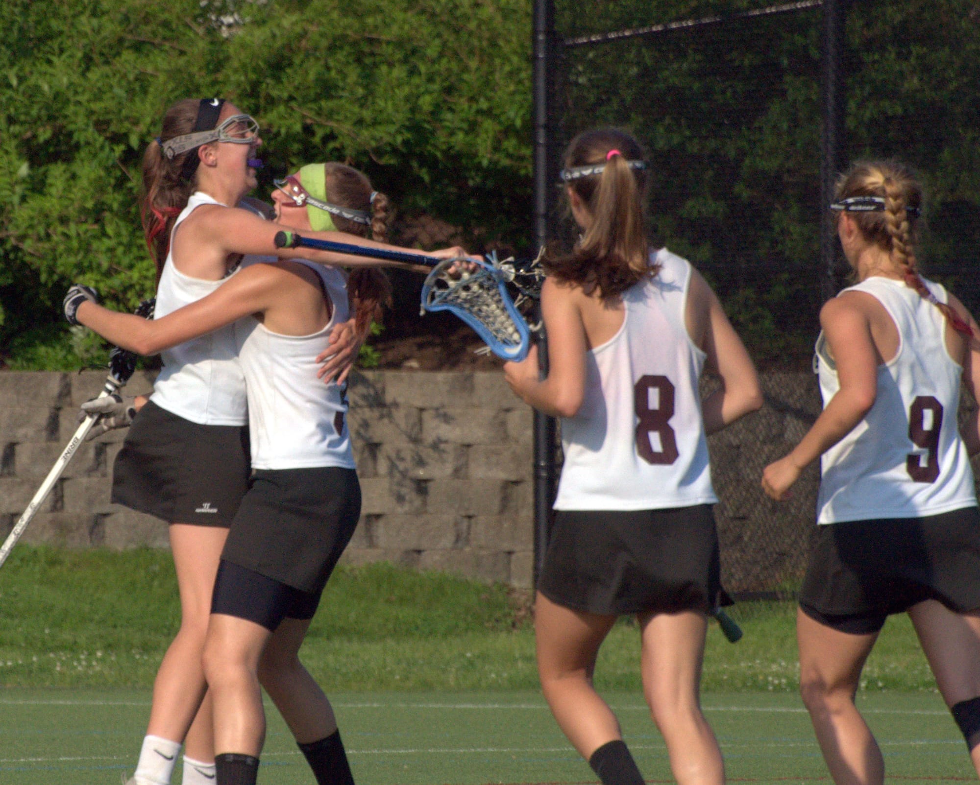 Members of the Hanover girls lacrosse team celebrate after scoring a goal during Saturday's semifinal against Bishop Guertin.