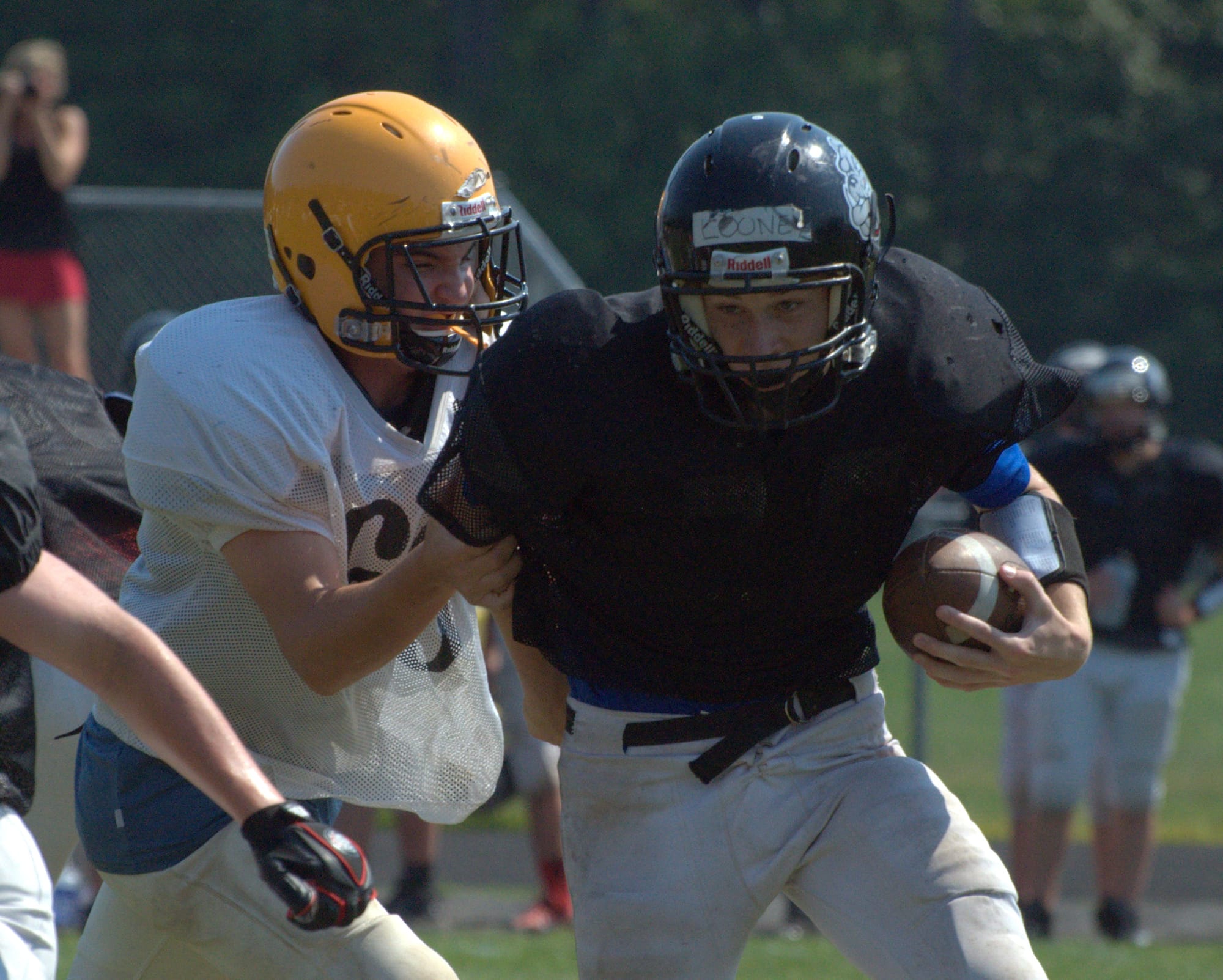 Bedford's Sean Looney carries the football during a scrimmage Wednesday against Souhegan.