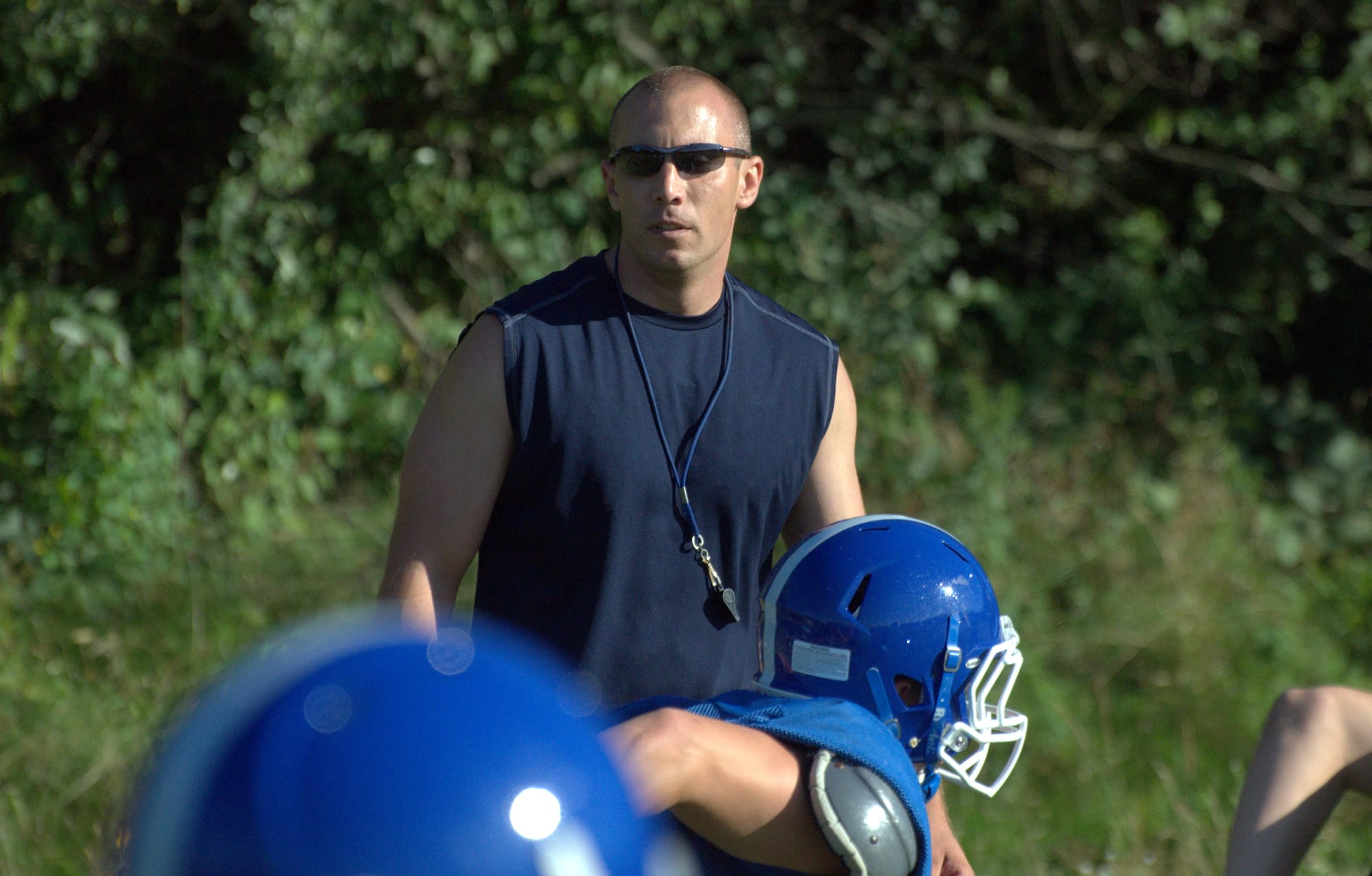 Hollis Brookline football coach Rich Bergskaug watches practice last week.
