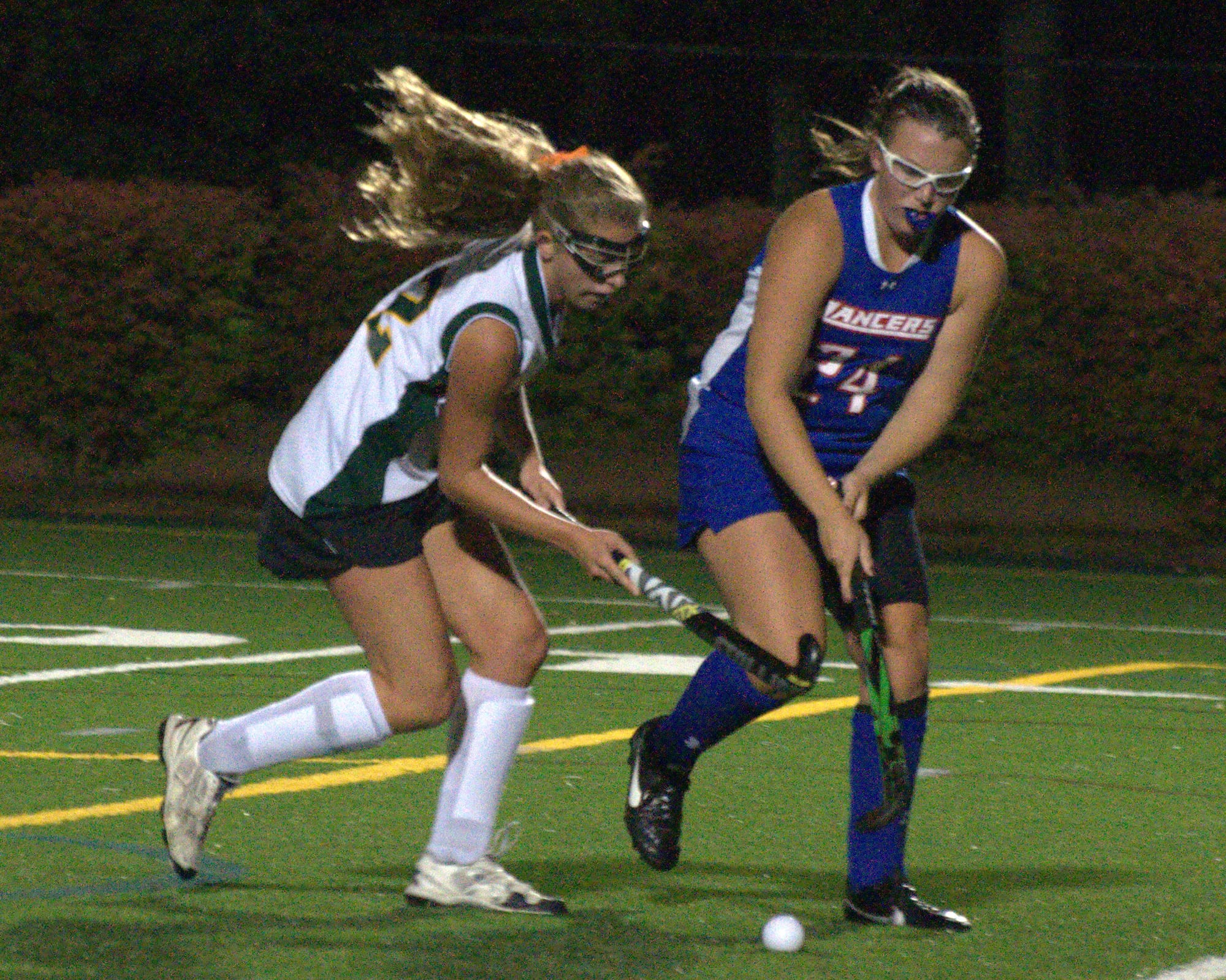 Bishop Guertin's Carly Caveny and Londonderry's Katie Montminy go after the ball during Wednesday's game.