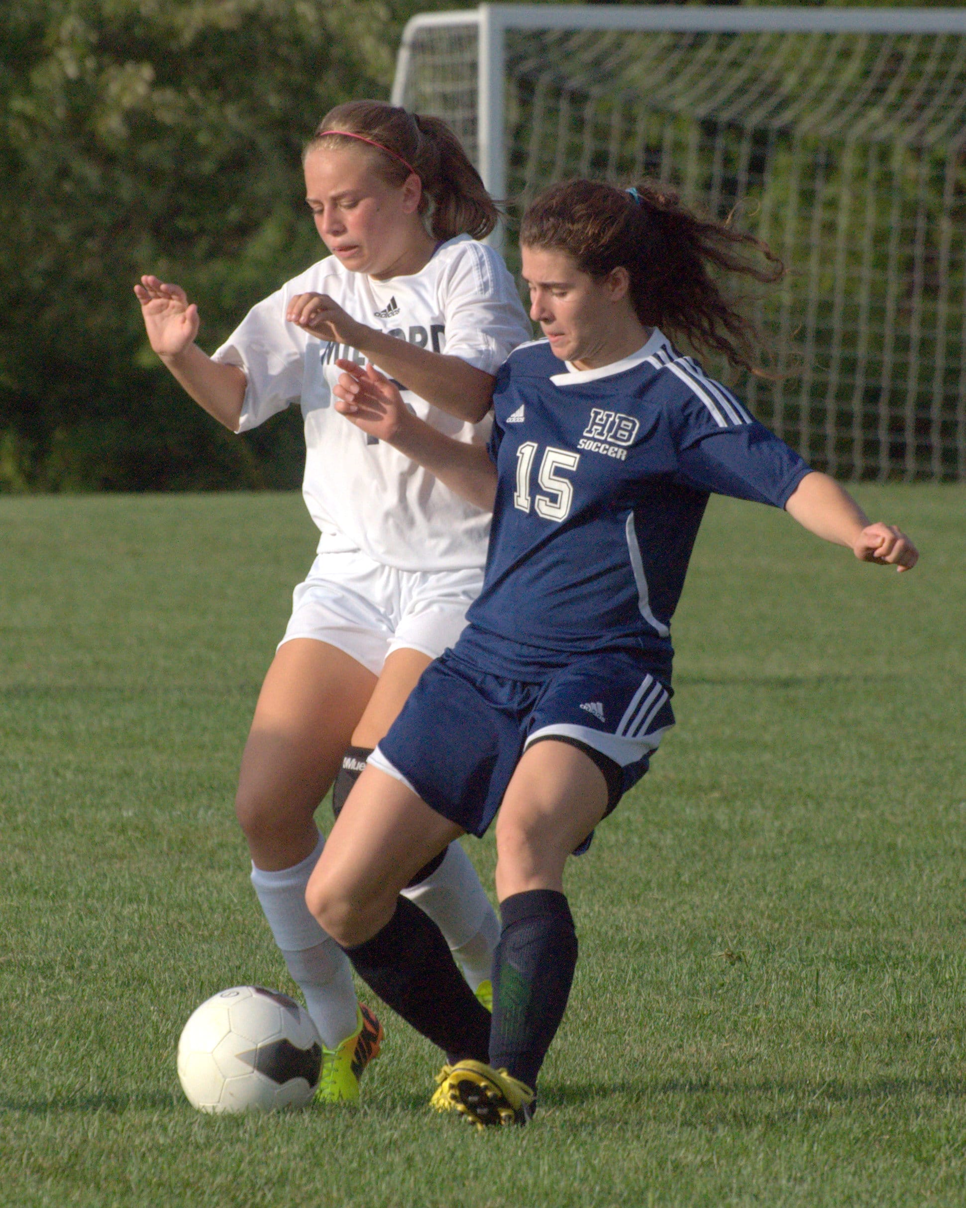Milford's Morgan Grill and Hollis Brookline's Lindsey Beauregard battle for the ball during Tuesday's game. For more photos, go to the Photo Album.