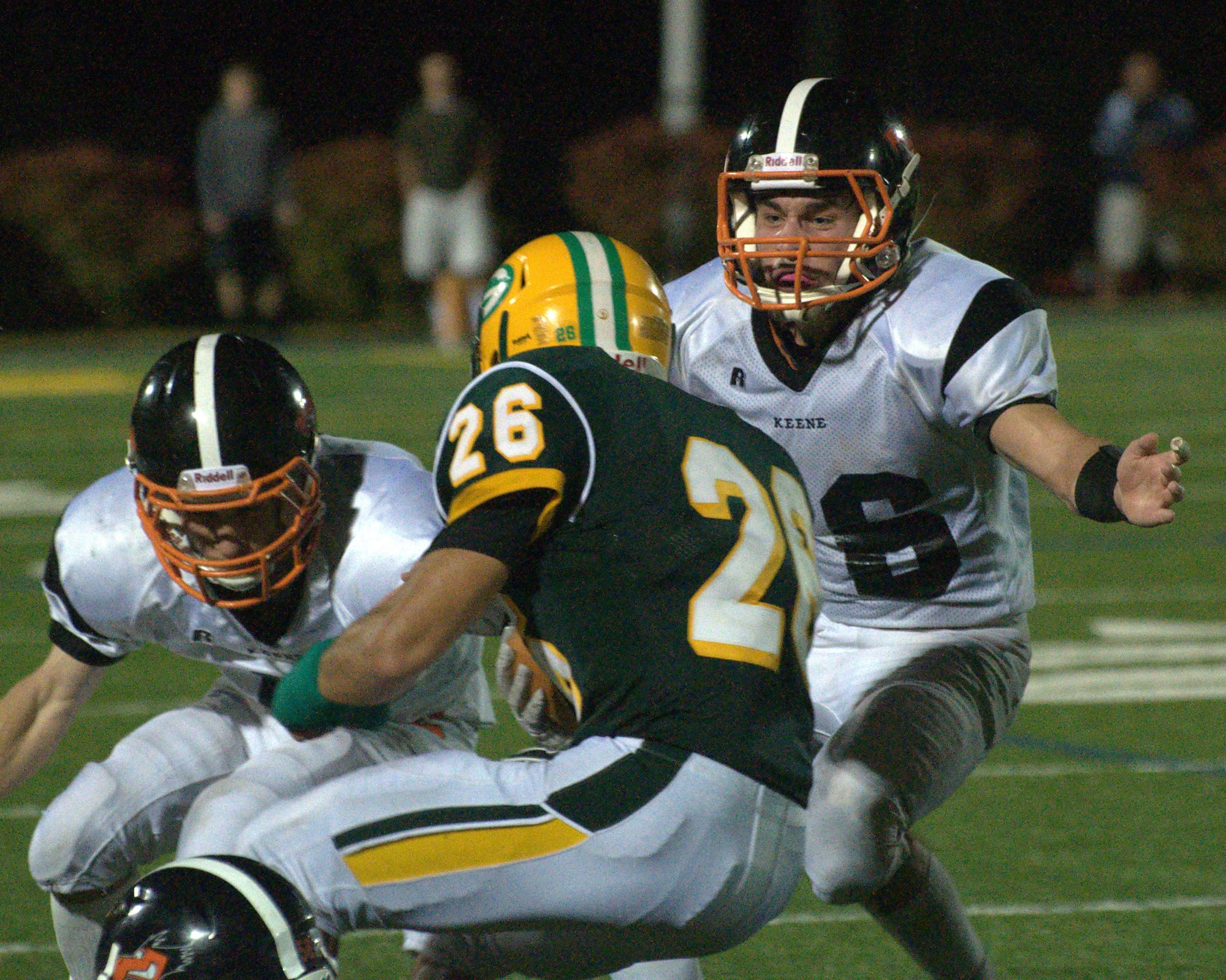 Keene's Thomas Galanes, left, and Riley Morris close in on Bishop Guertin's Mike Devereaux.