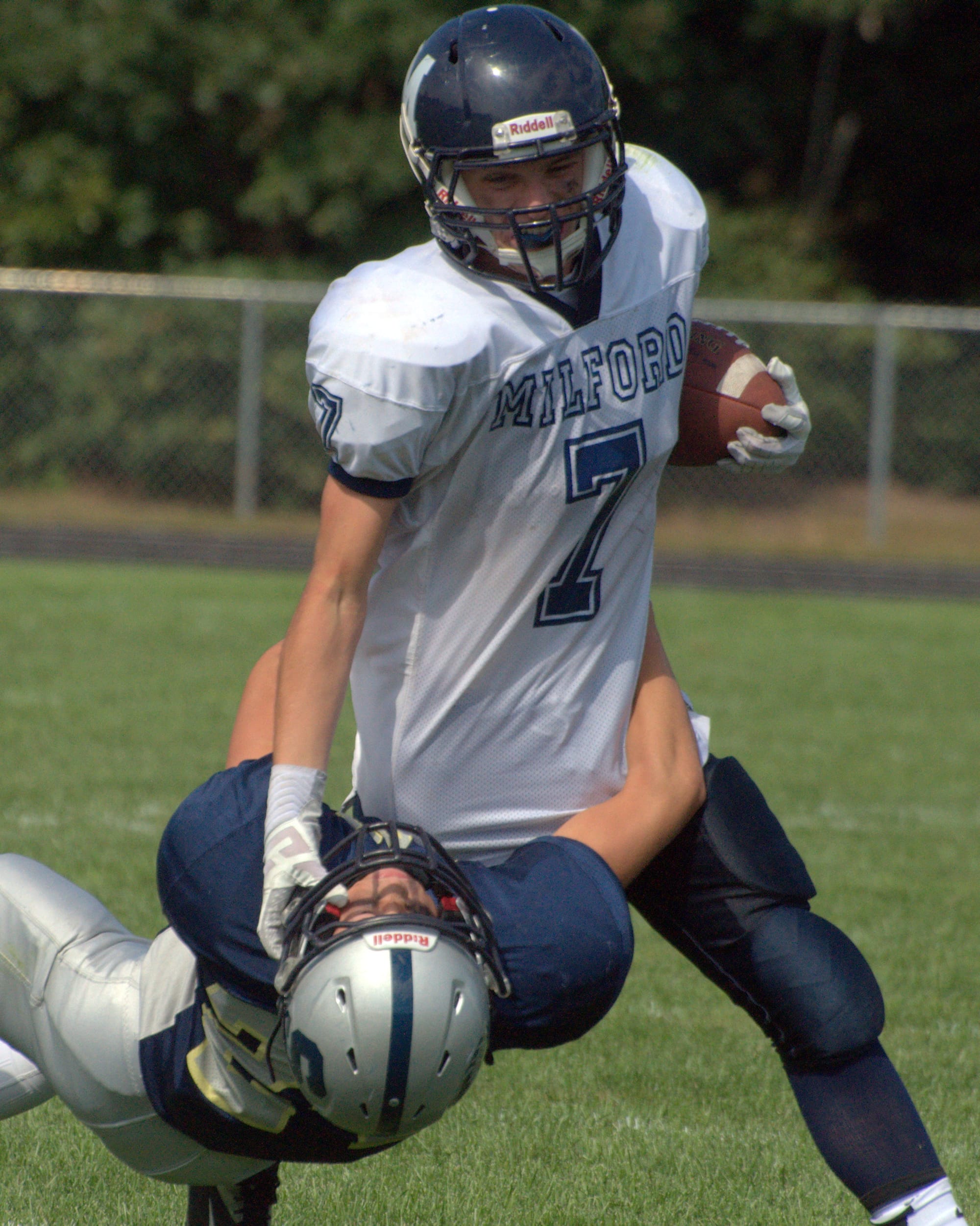 Milford's Mitchell Banuskevich tries to fight off a tackle during Saturday's game against Sanborn.