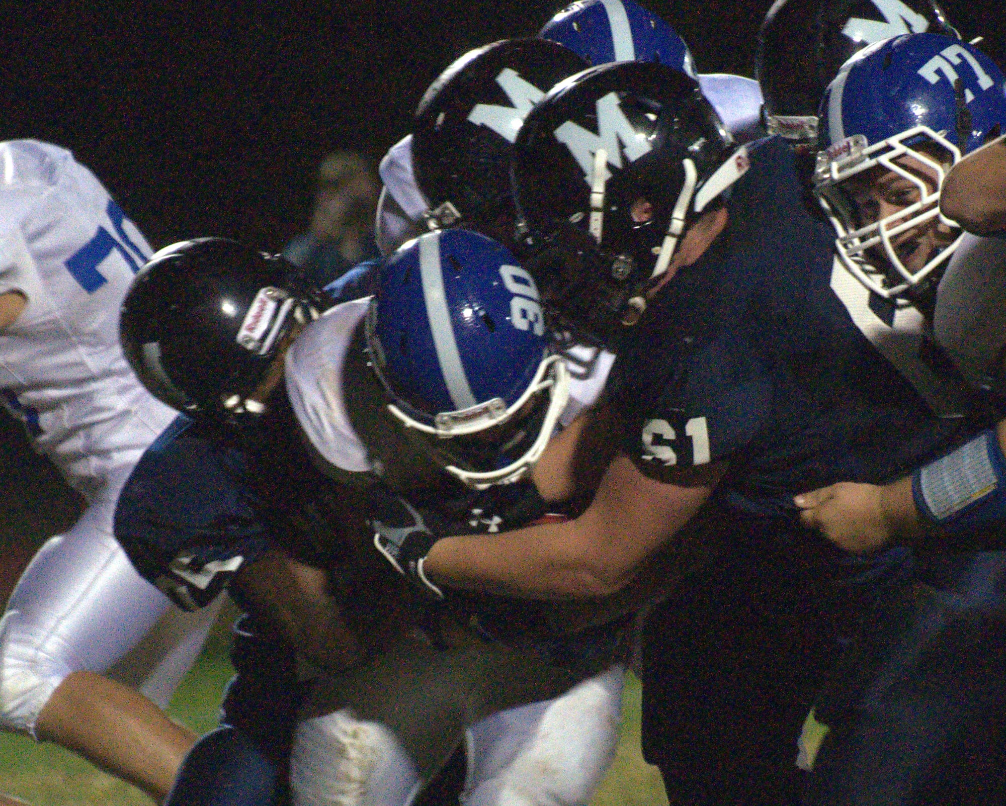 The Milford defense swarms a Hollis Brookline ball carrier during Friday's game.