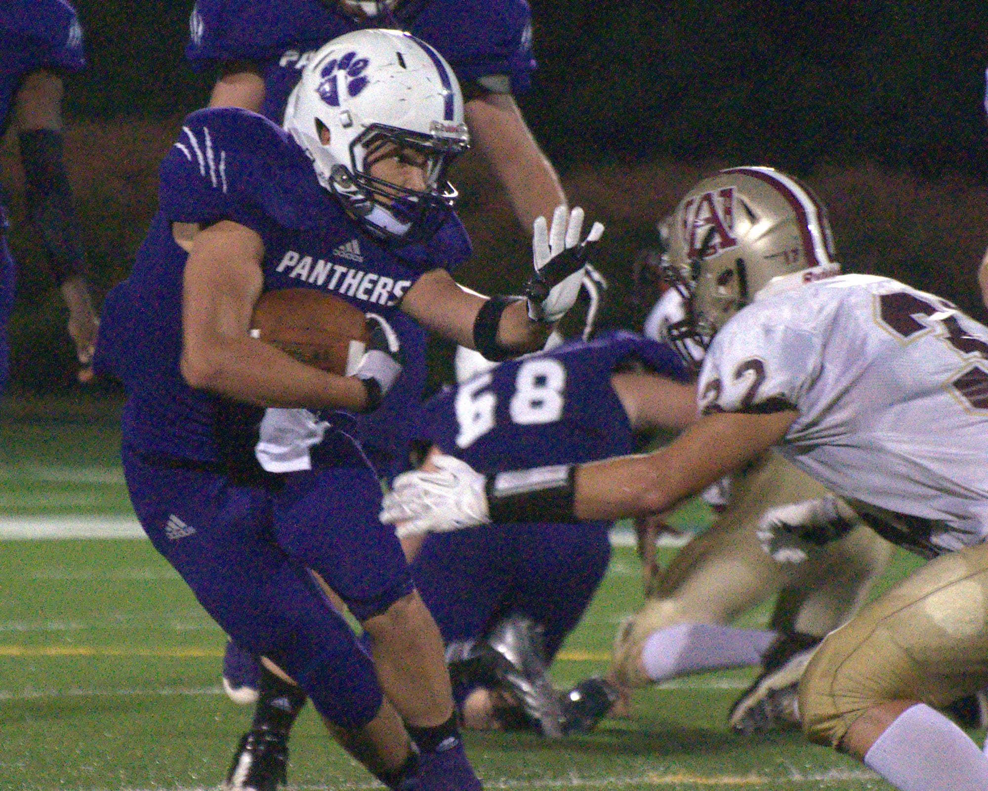 Nashua South's Josh Perry tries to fight off a tackle during Thursday's first half against Alvirne.