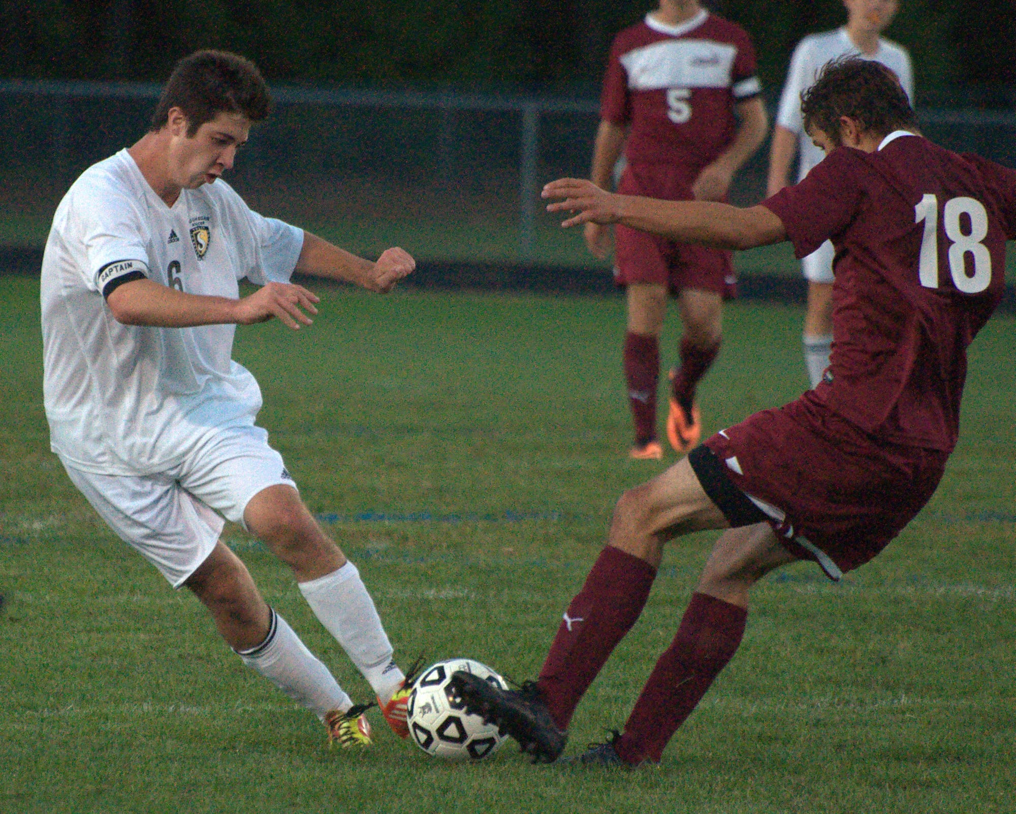 Souhegan's Mike Hayden and Portsmouth's Carter Madden go after the ball during Monday's game.