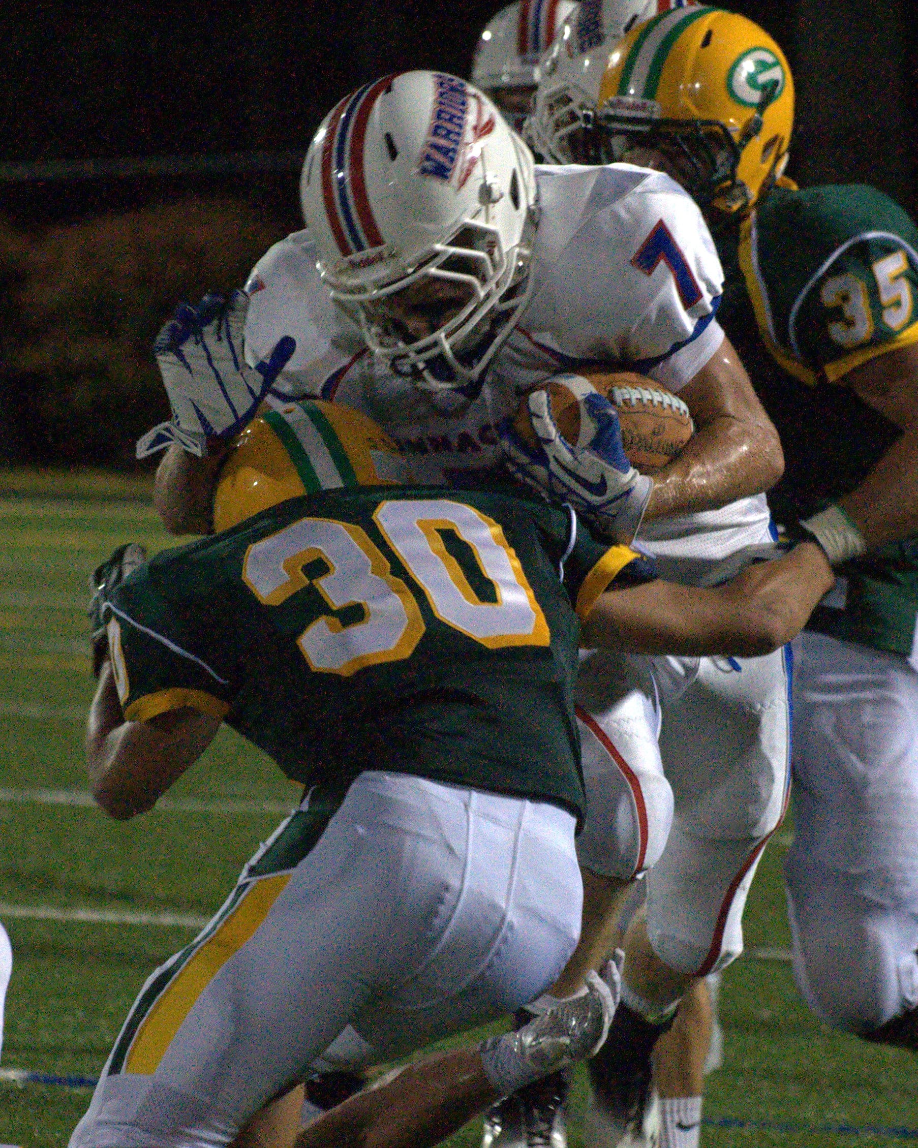 Bishop Guertin's Stavros Anagnost tries to tackle Winnacunnet's Clint Felch during Saturday's game.
