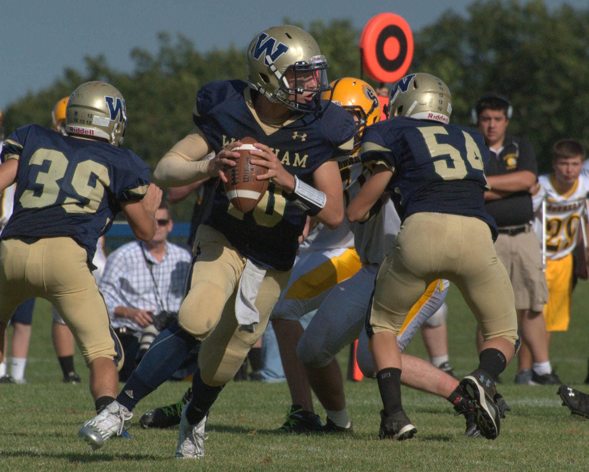 Windham quarterback Brendan McGinnis rolls out during Saturday's game against Souhegan.