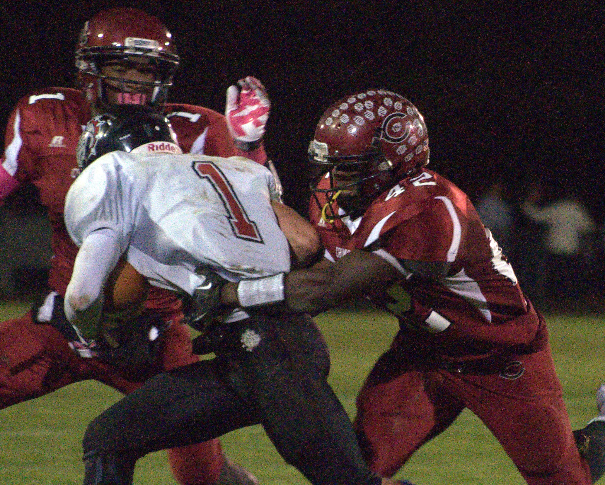 Concord's Walters Ndi helps to tackle Bedford's Michael Vailas during Fridays' game.