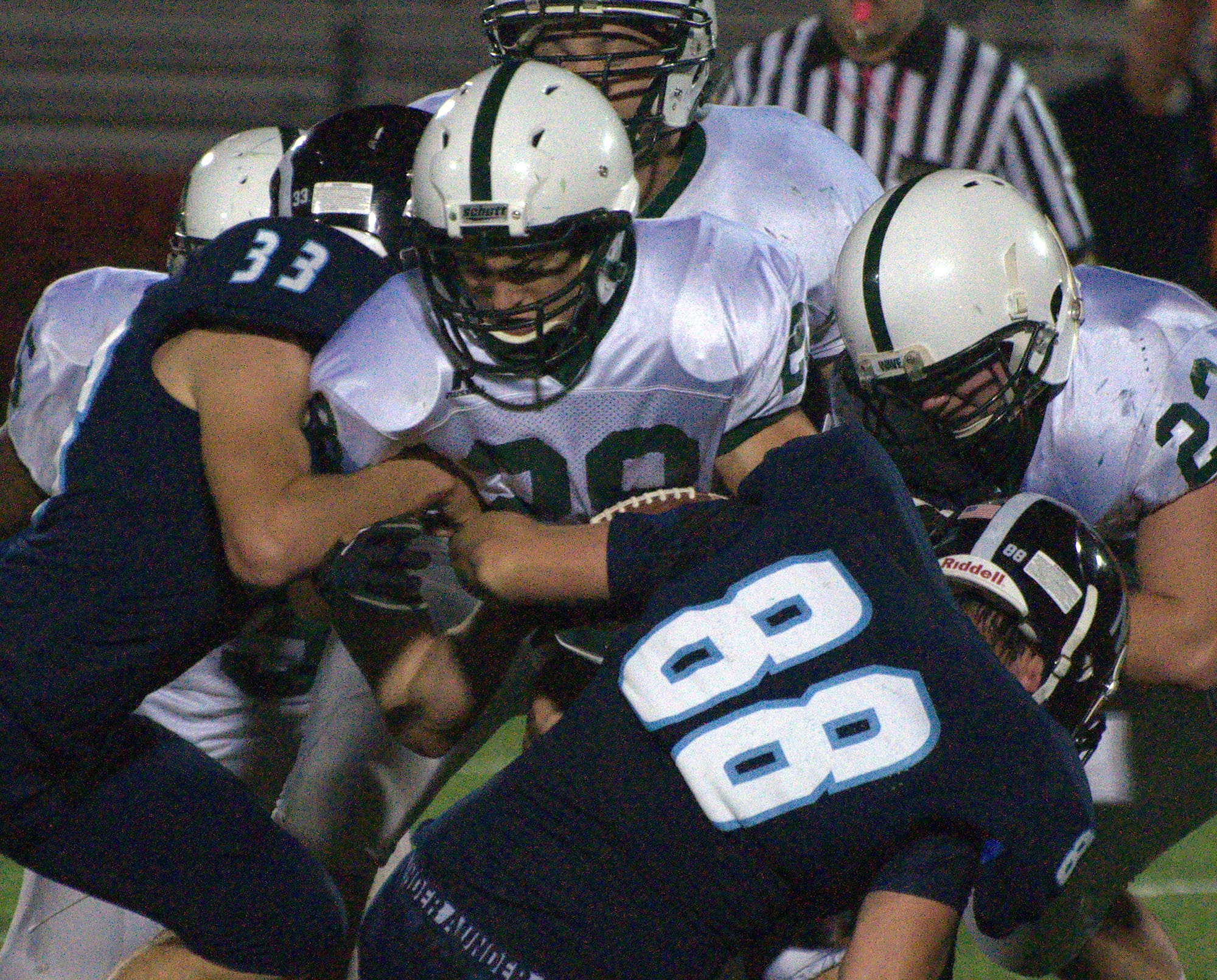 Dover's Cam Rewucki tries to fight through a tackle.