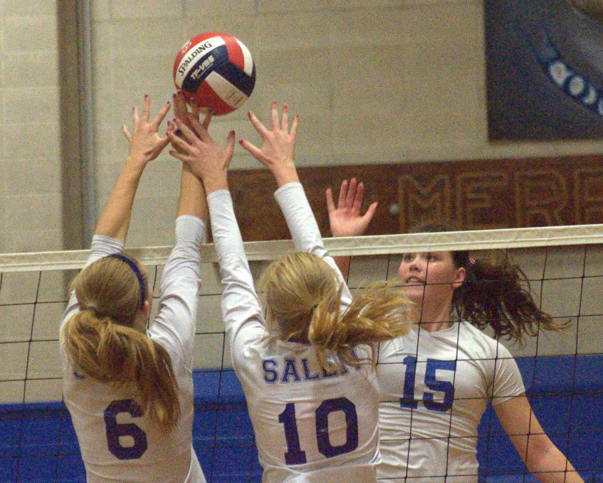 Merrimack's Jen Coffey watches as Salem's Shari Juranovits, left, and Alyssa Kolbert block her hit during Wednesday's match.