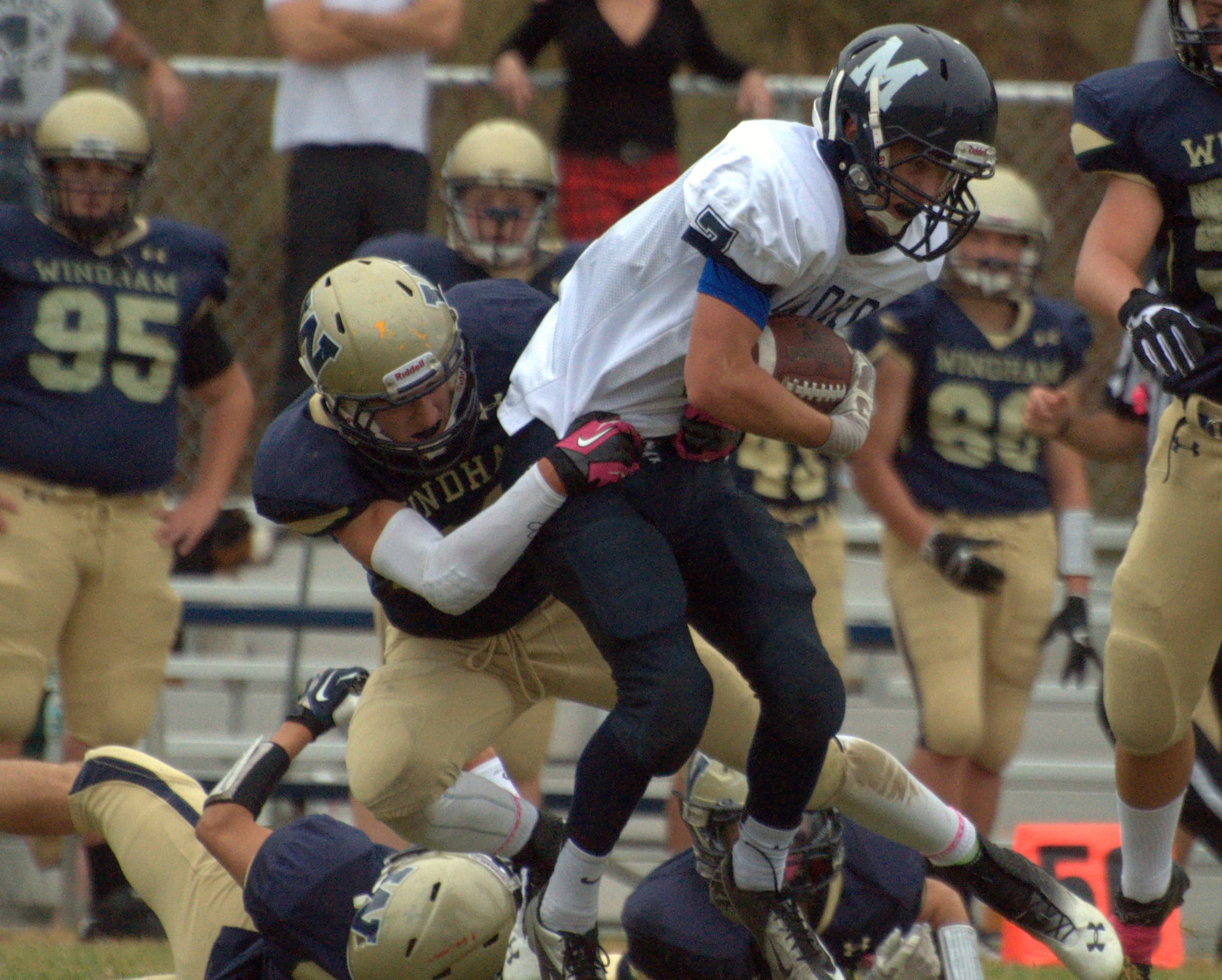 Milford's Mitchell Banuskevich is wrapped up by a the Windham defense during Saturday's game.