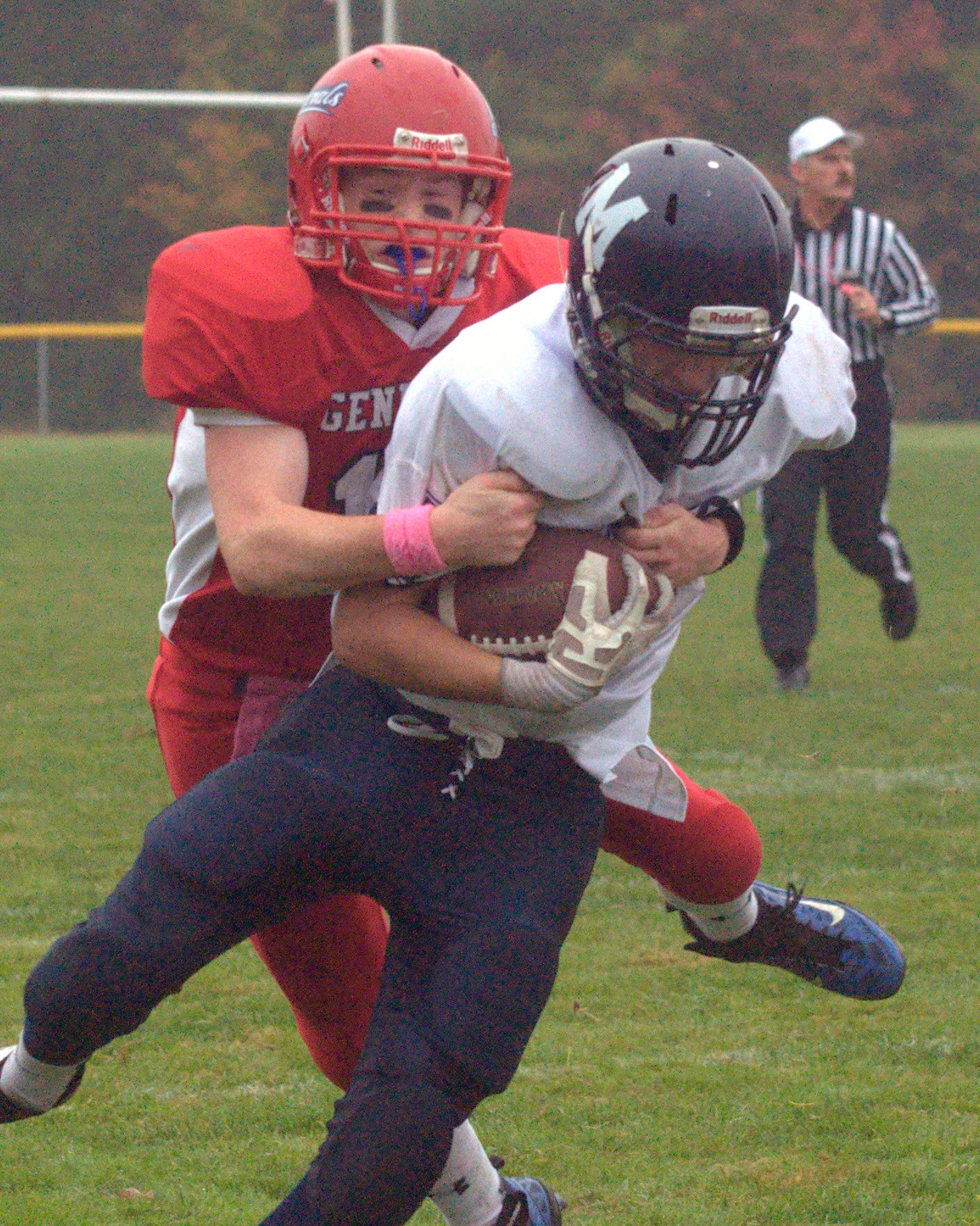 John Stark's Gage Huard tries to bring down Milford's Mitchell Banuskevich during Saturday's game.