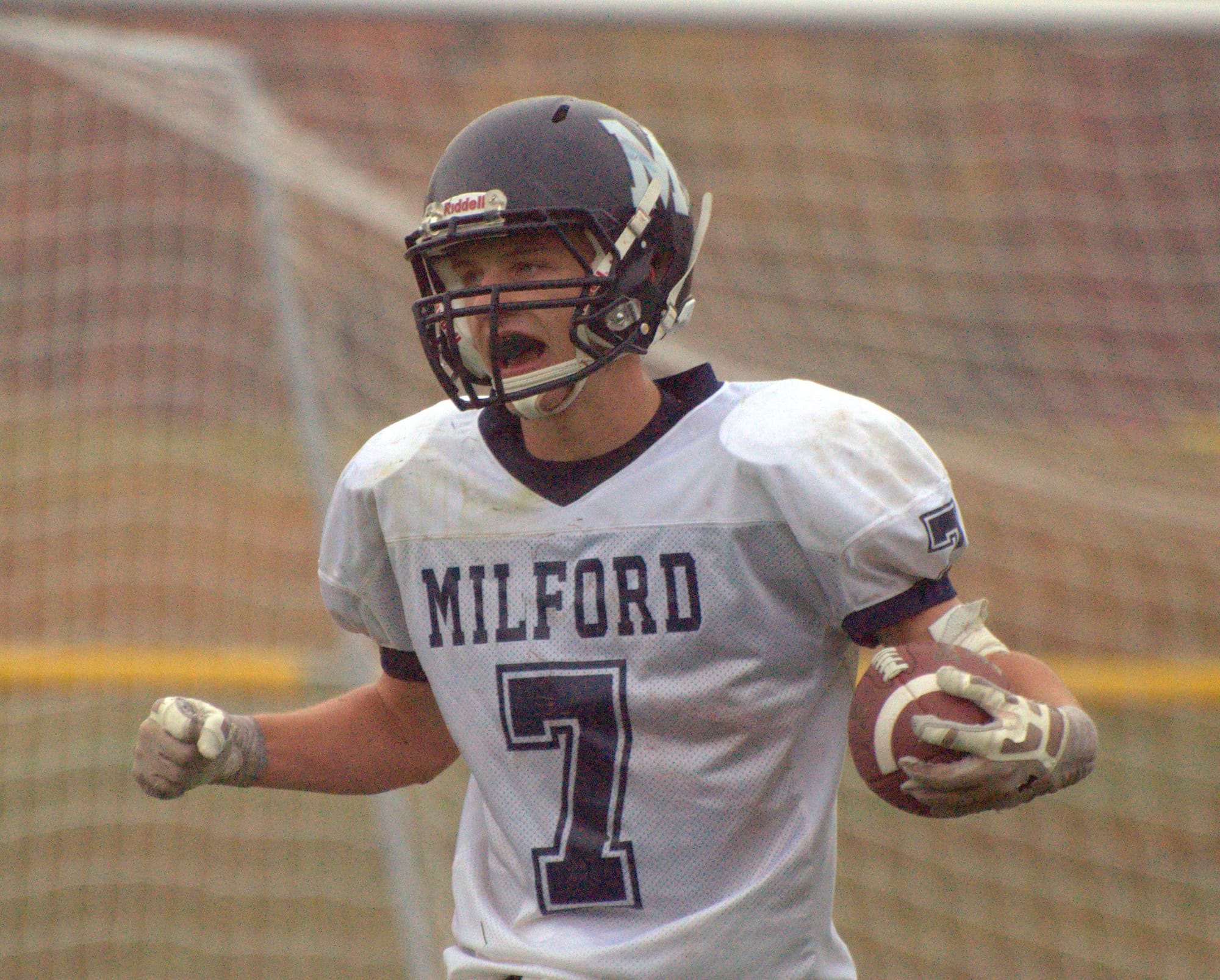 Milford's Mitchell Banuskevich celebrates after scoring a touchdown during Saturday's game against John Stark.