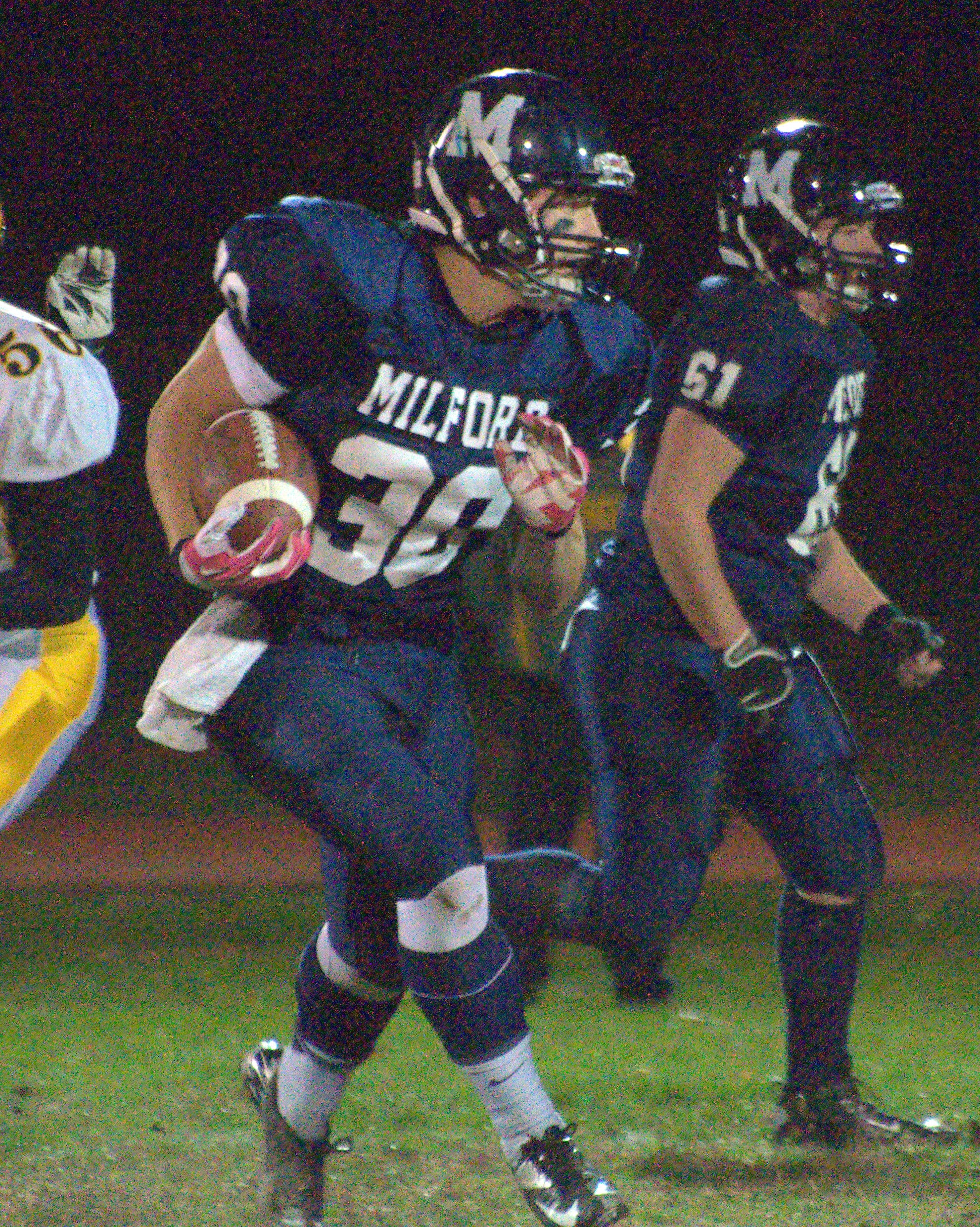 Milford's Evan Perron carries the ball during Friday's game.