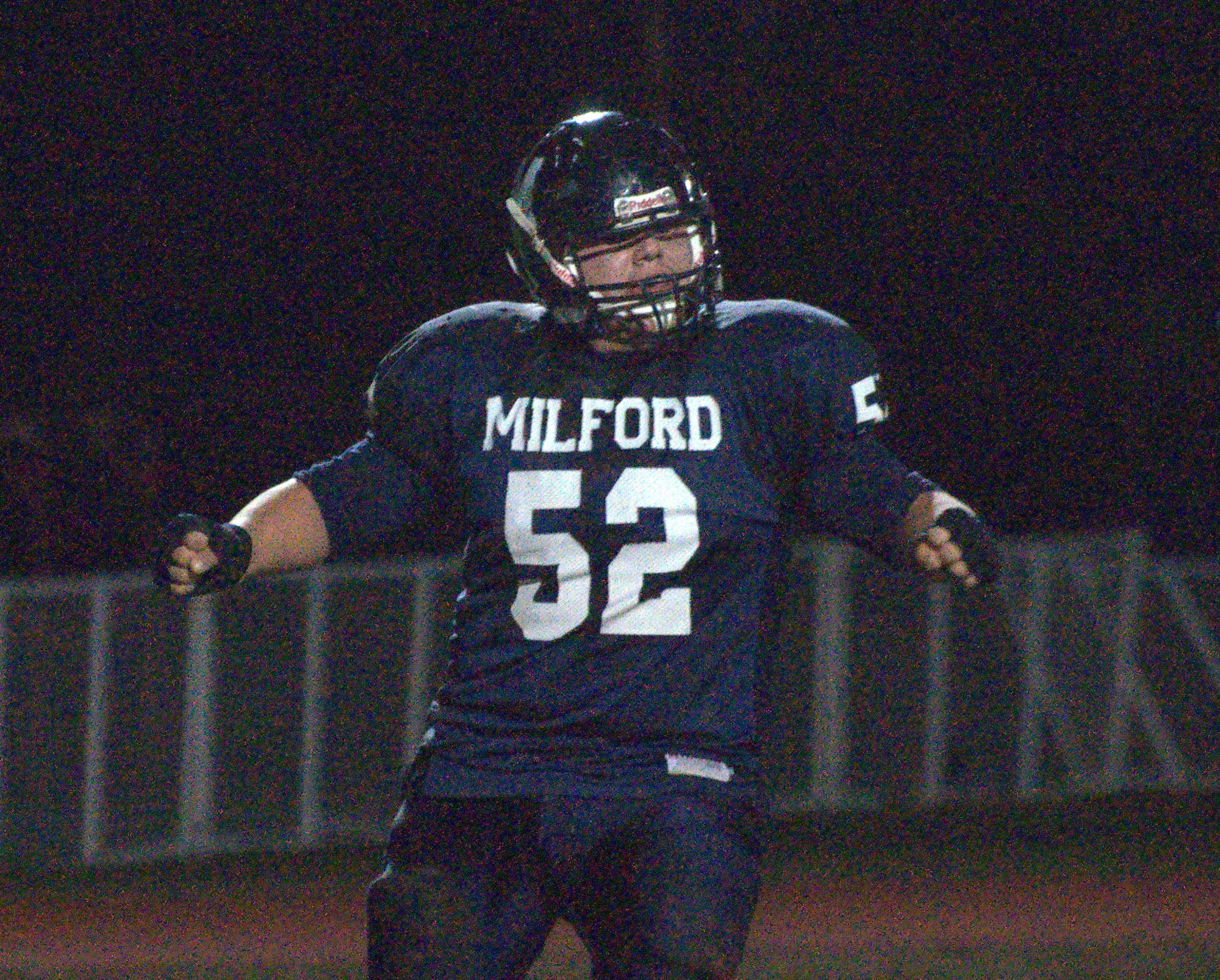 Milford's Travis Hughes celebrates after a sack of Souhegan's Isaac Nevrla.