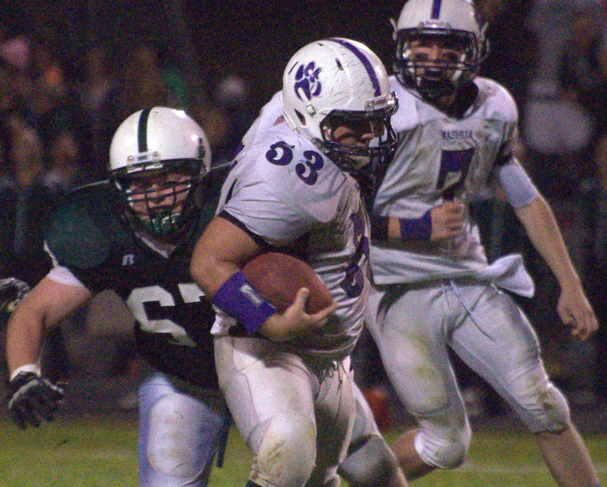 Nashua South's Tyler Boudreau runs with the ball after making an interception.
