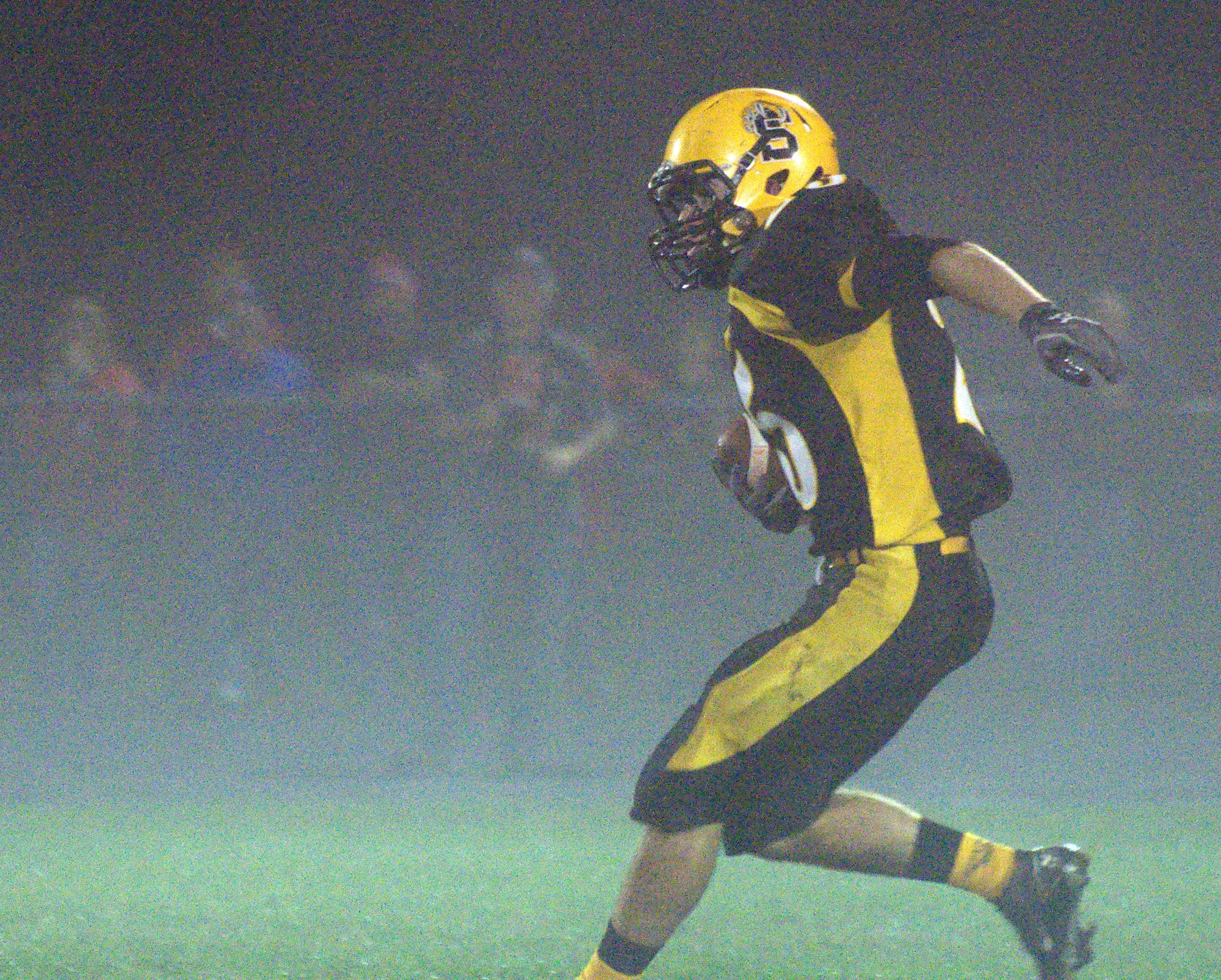 Souhegan's Drew Prescott carries the ball during Friday night's game against John Stark.