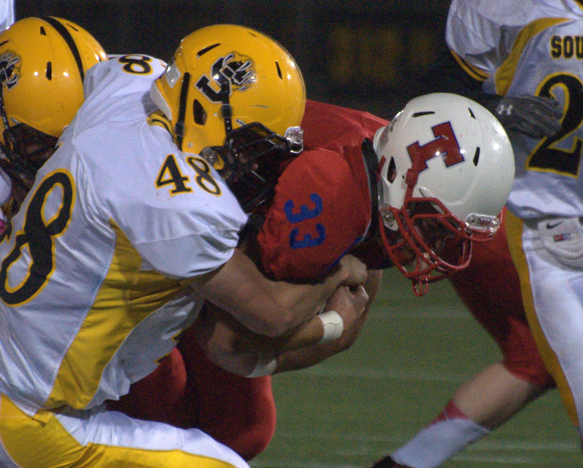 Souhegan's Timothy Kearney tackles Trinity's Will Sheppard during Saturday's game.