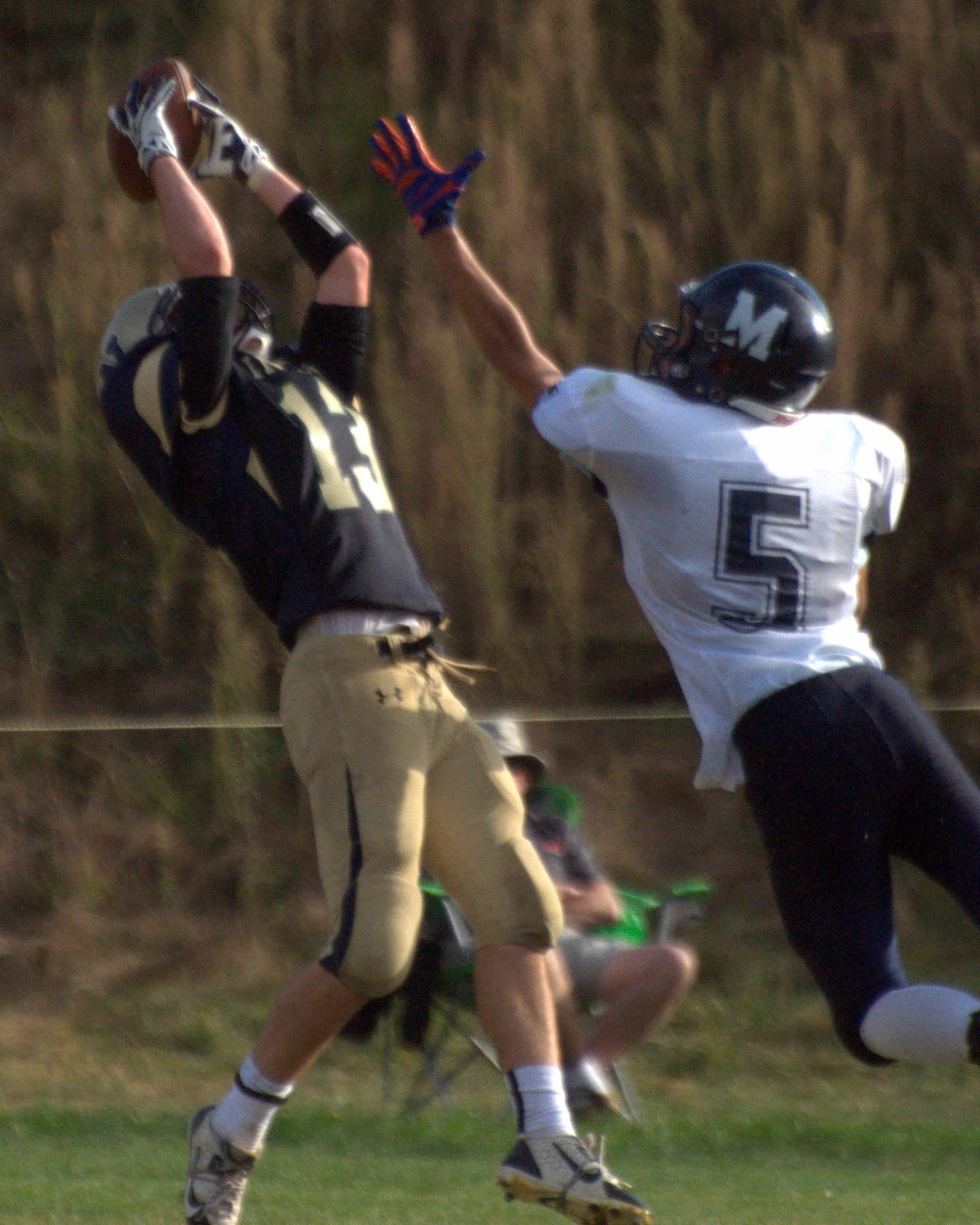 Windham's Anthony Gallo tries to haul in a pass as Milford's Ian Michaud defends.